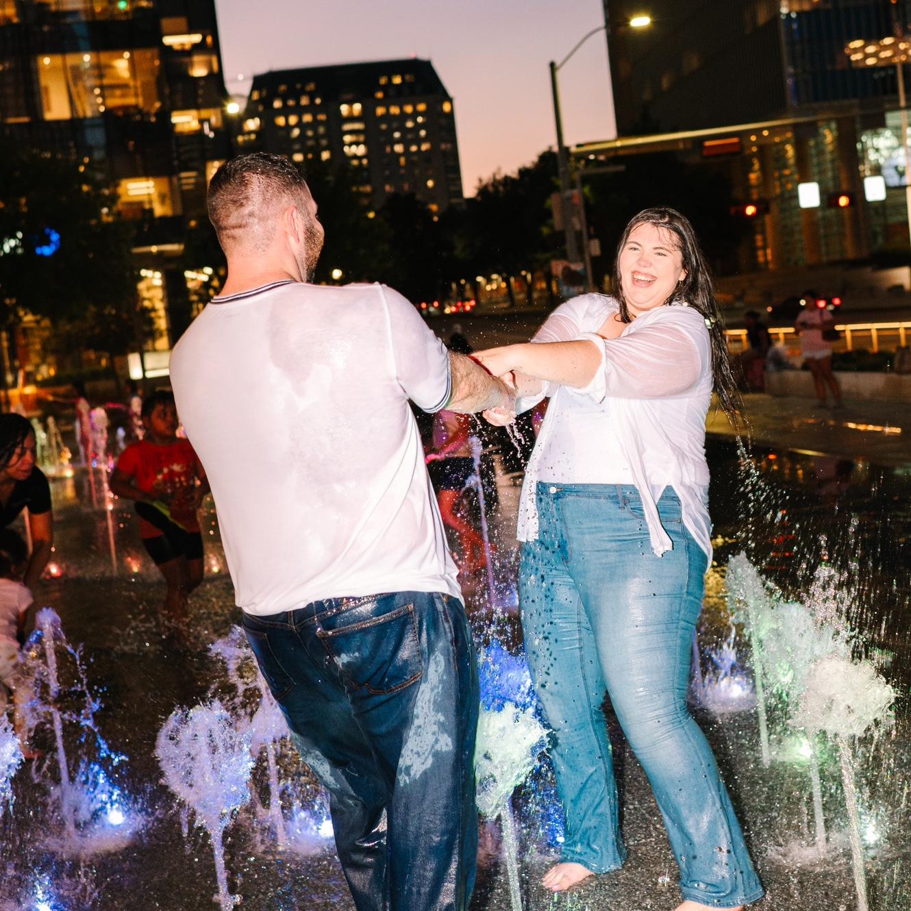 We ended our engagement photo session running and dancing through the Klyde Warren Park fountains in Dallas!