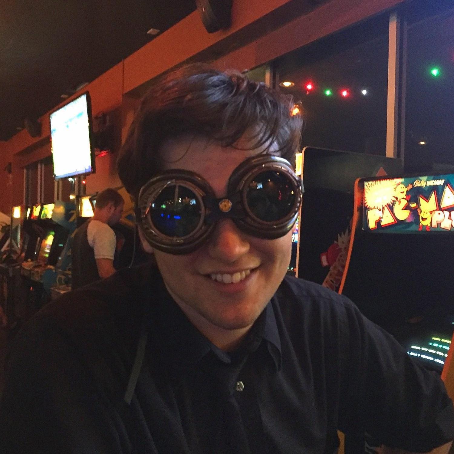 Robert tries on Sarah's steampunk goggles; summer 2016.