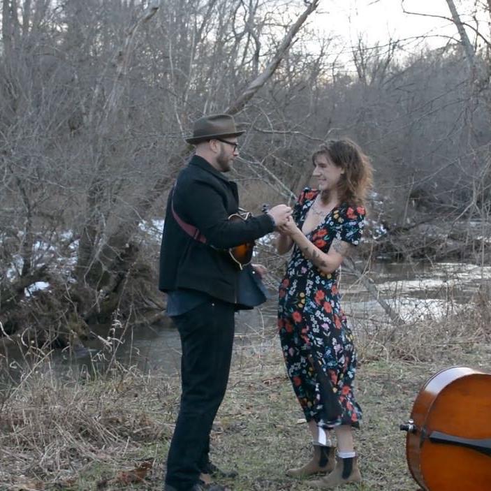Julia crying with happiness that John said yes and trying to put a too small ring on John's finger. 