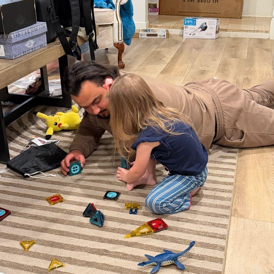 The Groom and flower girl take a play break after the wedding