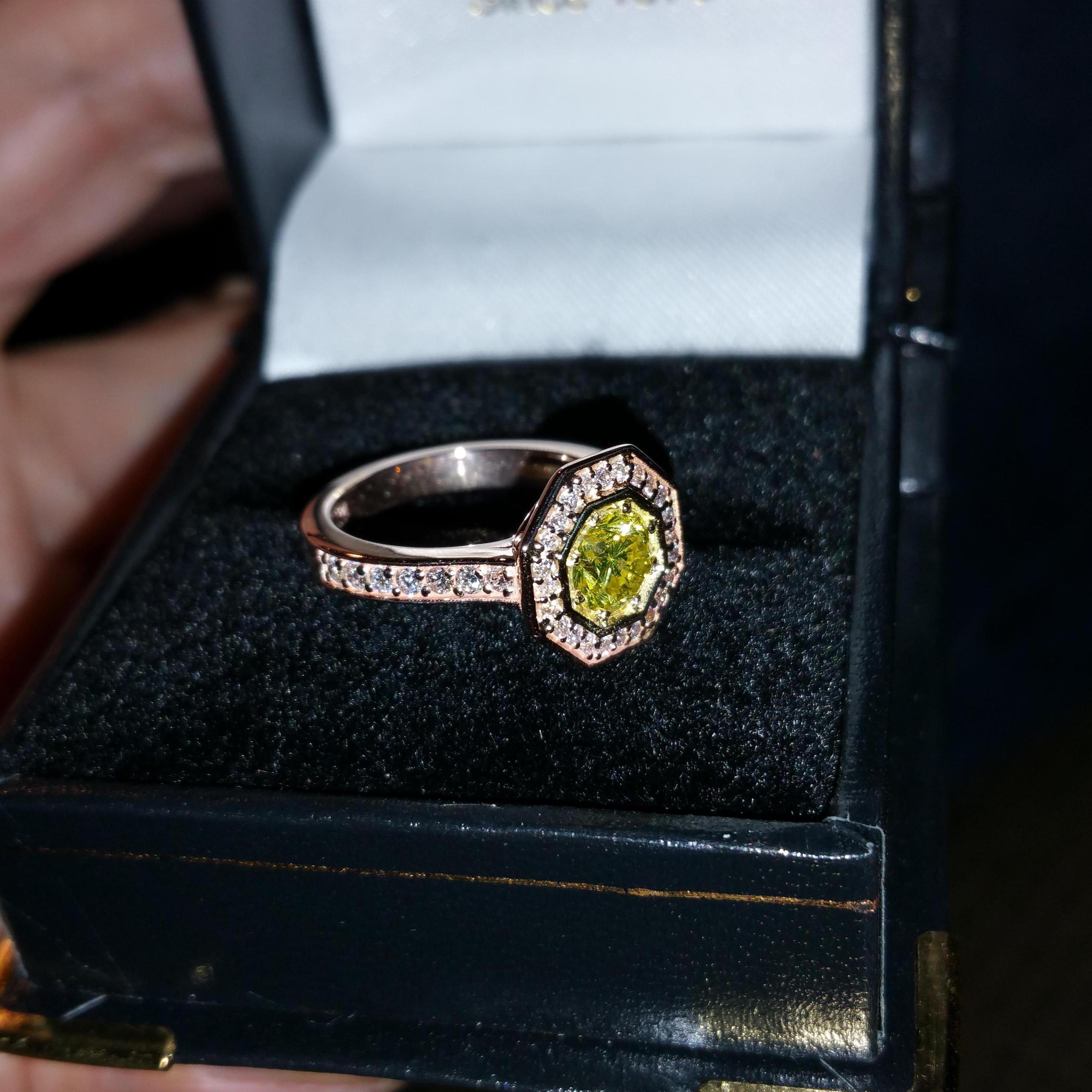 Skylar had this ring custom made to Jessica's preferred Art Deco style. The band is rose gold with a yellow diamond centered.