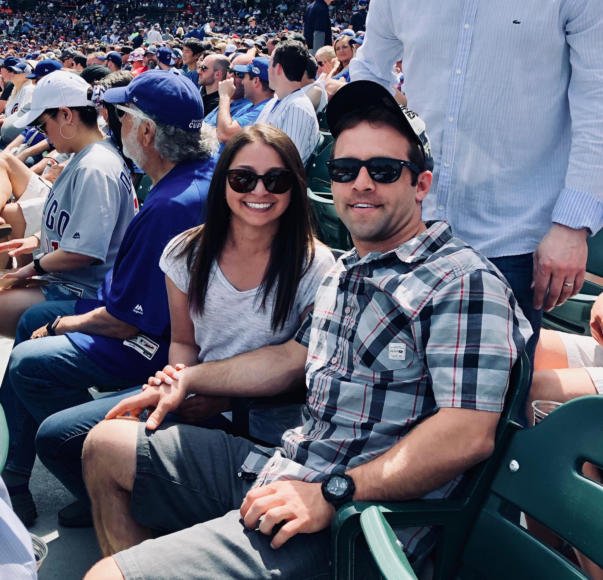 Phil enjoying himself at a Cubs game while I wish we were at a different field