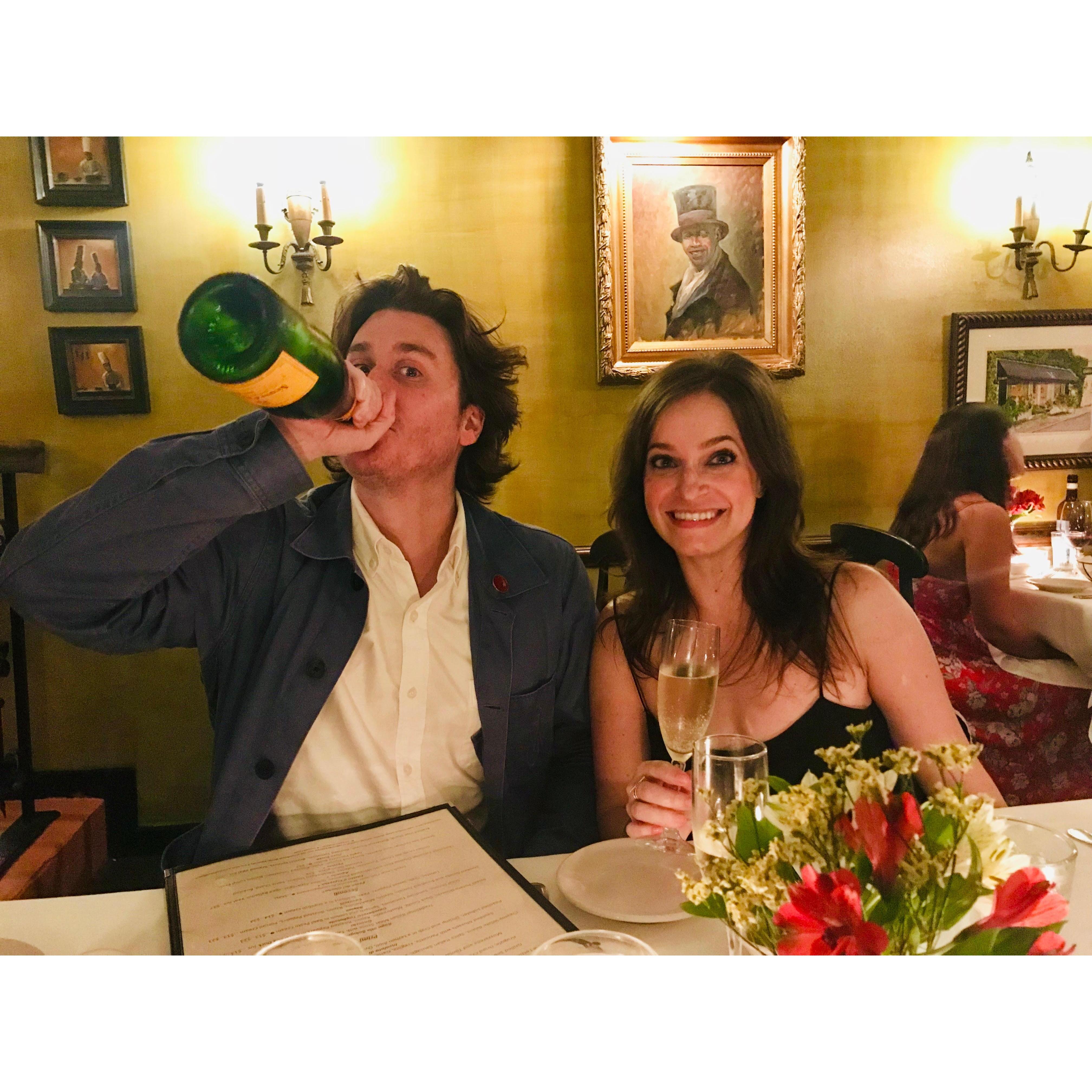Jessica having a glass of champagne while Steve has the bottle. In Charleston.