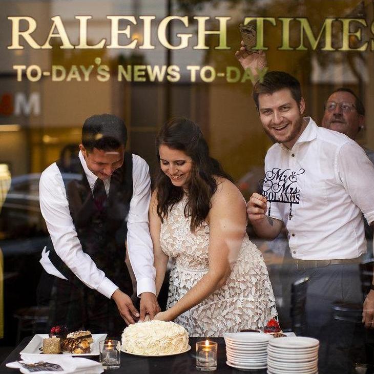Cutting the gorgeous cake my mom made for our mini reception at The Raleigh Times after getting married at the courthouse.