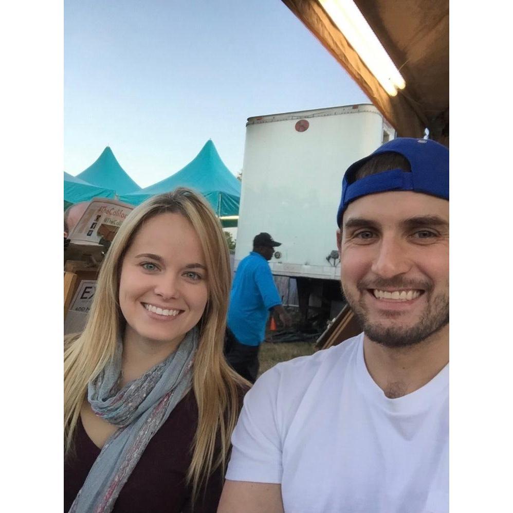 A selfie of us sitting for our very first caricature drawing.