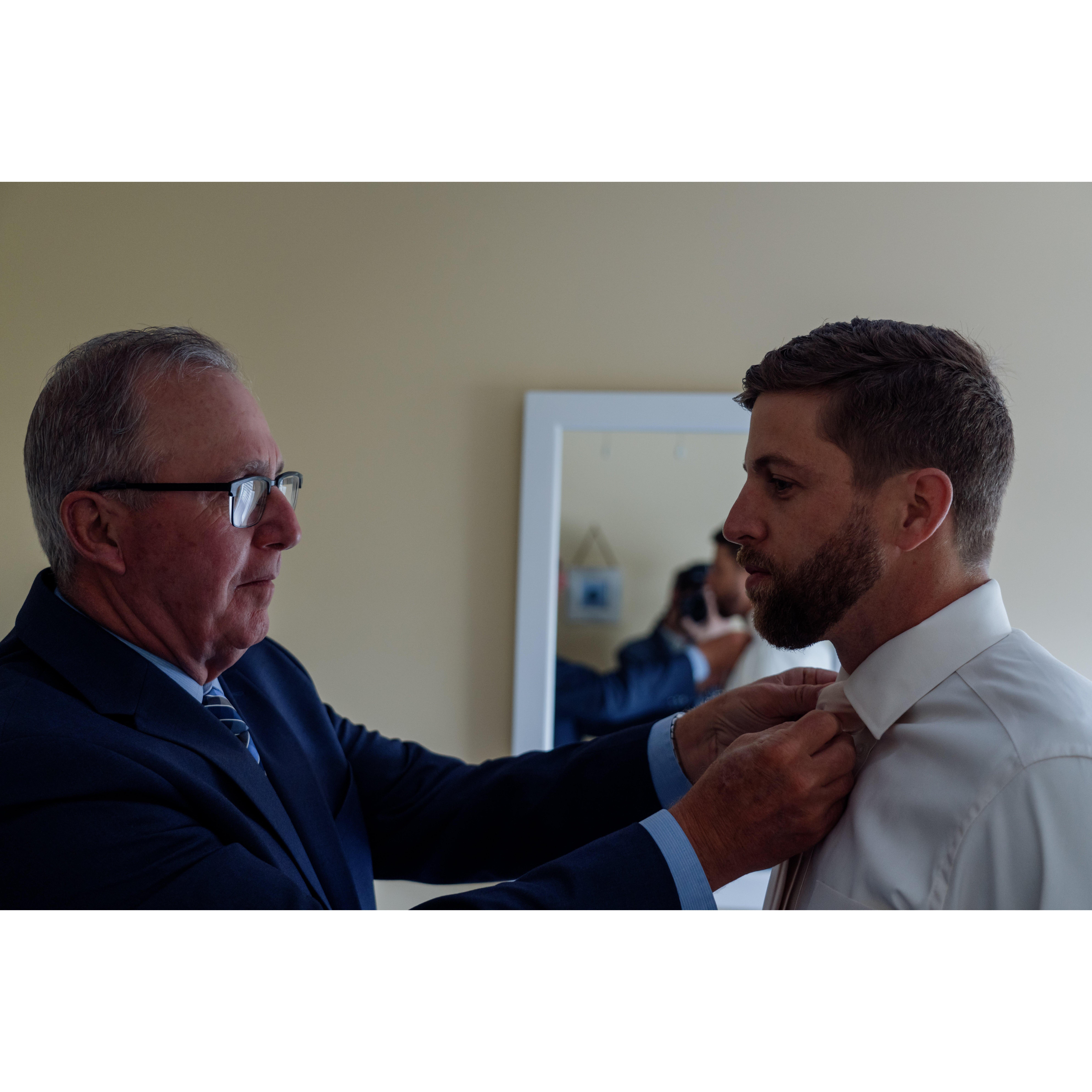 Mark's dad, Robert, helping him get ready