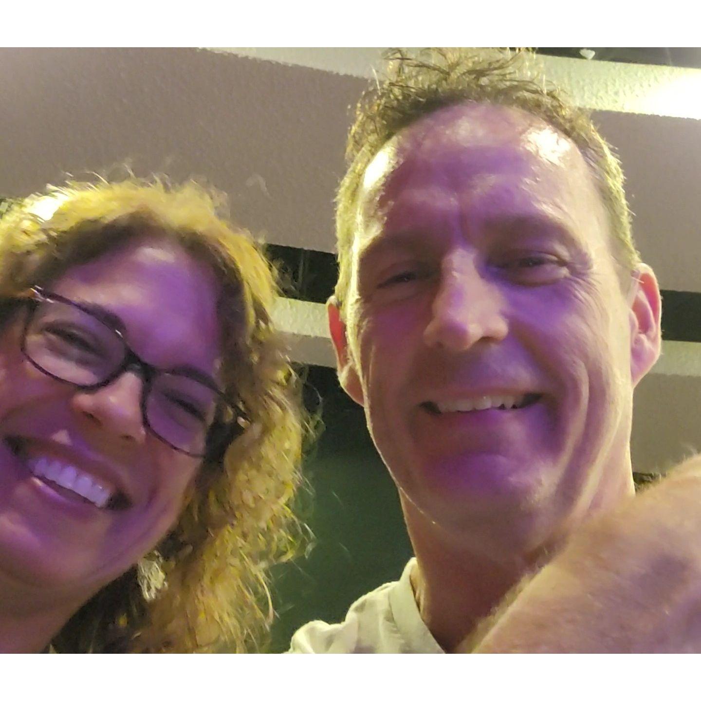 August 27, 2024. Jim's smiling because he doesn't yet know he's going to get invited on stage as part of the act. His worst nightmare! "I tried to hide us in the corner, I really did." LOL!