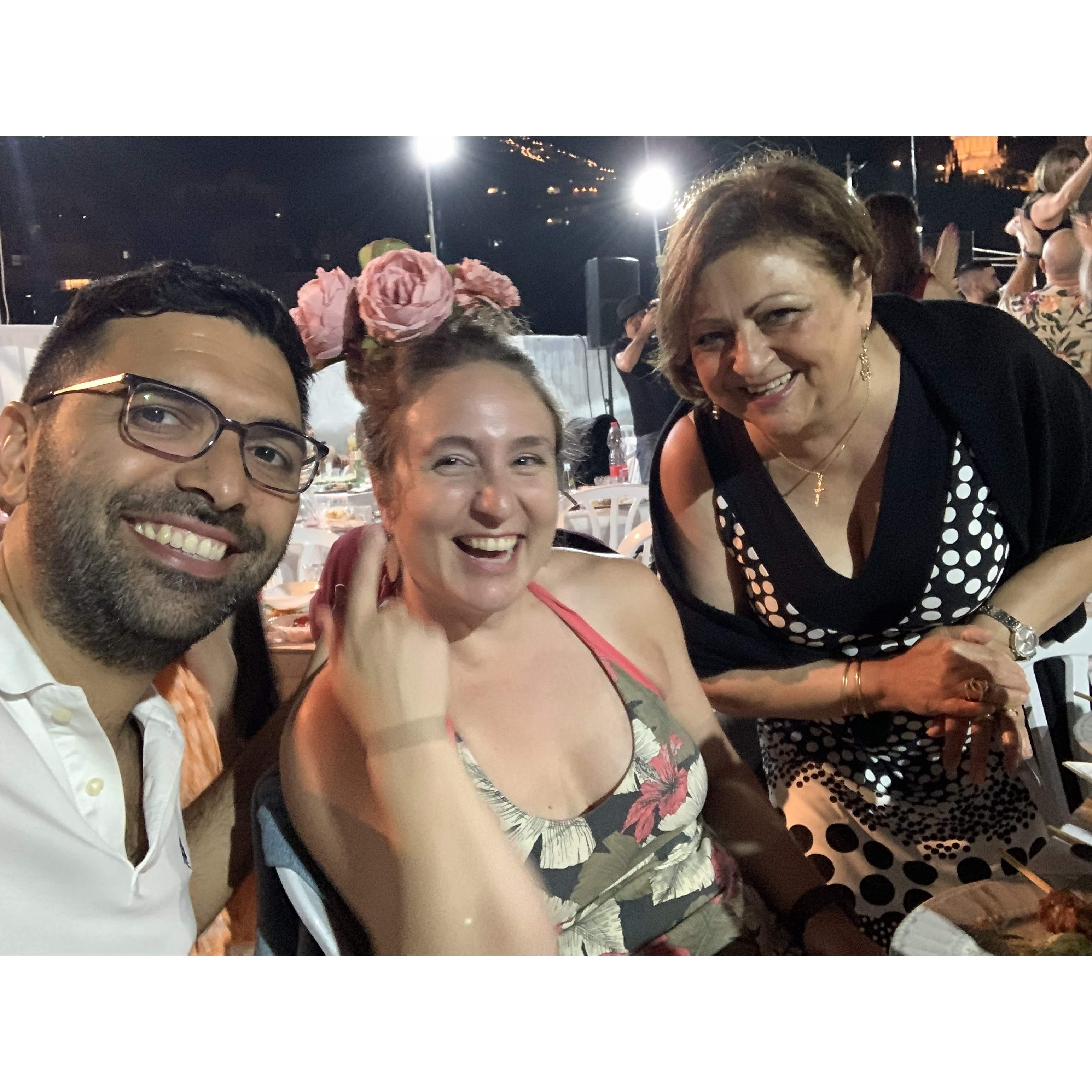 celebrating at a rooftop event in Haifa - Nura (Bishara's little cousin) put flowers in my hair! That's Bishara's mom with us!