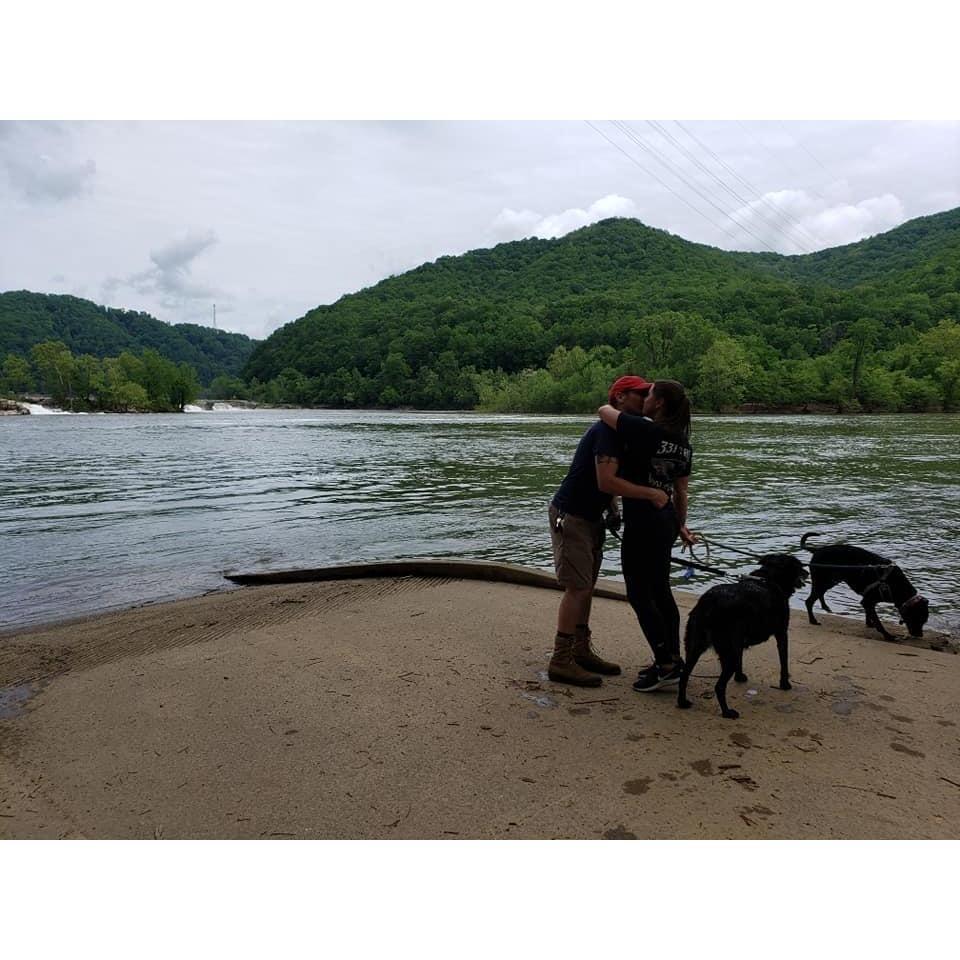 First kiss as newly engaged couple, as our dogs try to drag us into the river.