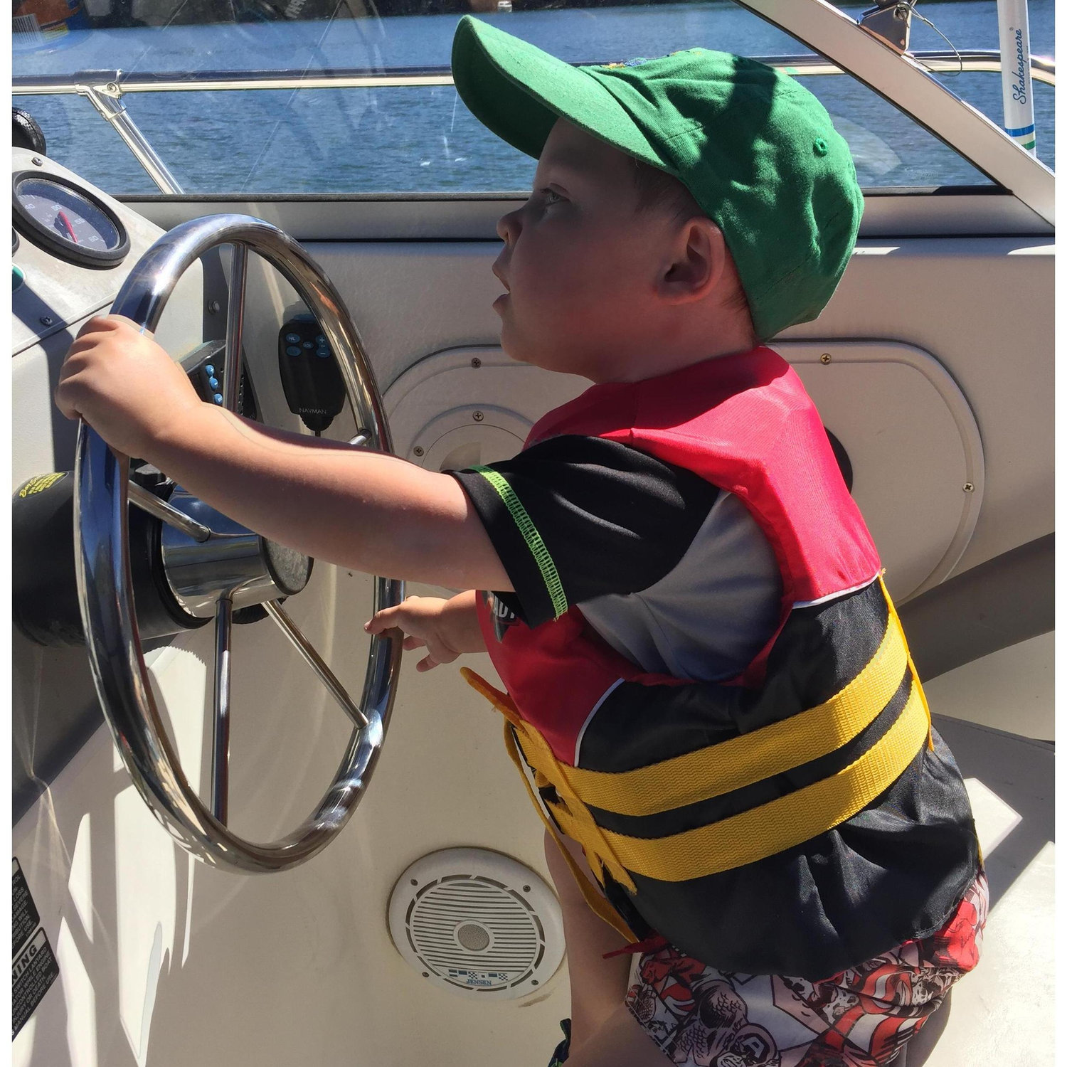 Paxton driving Grandpa George and Grandma Jeanette’s boat