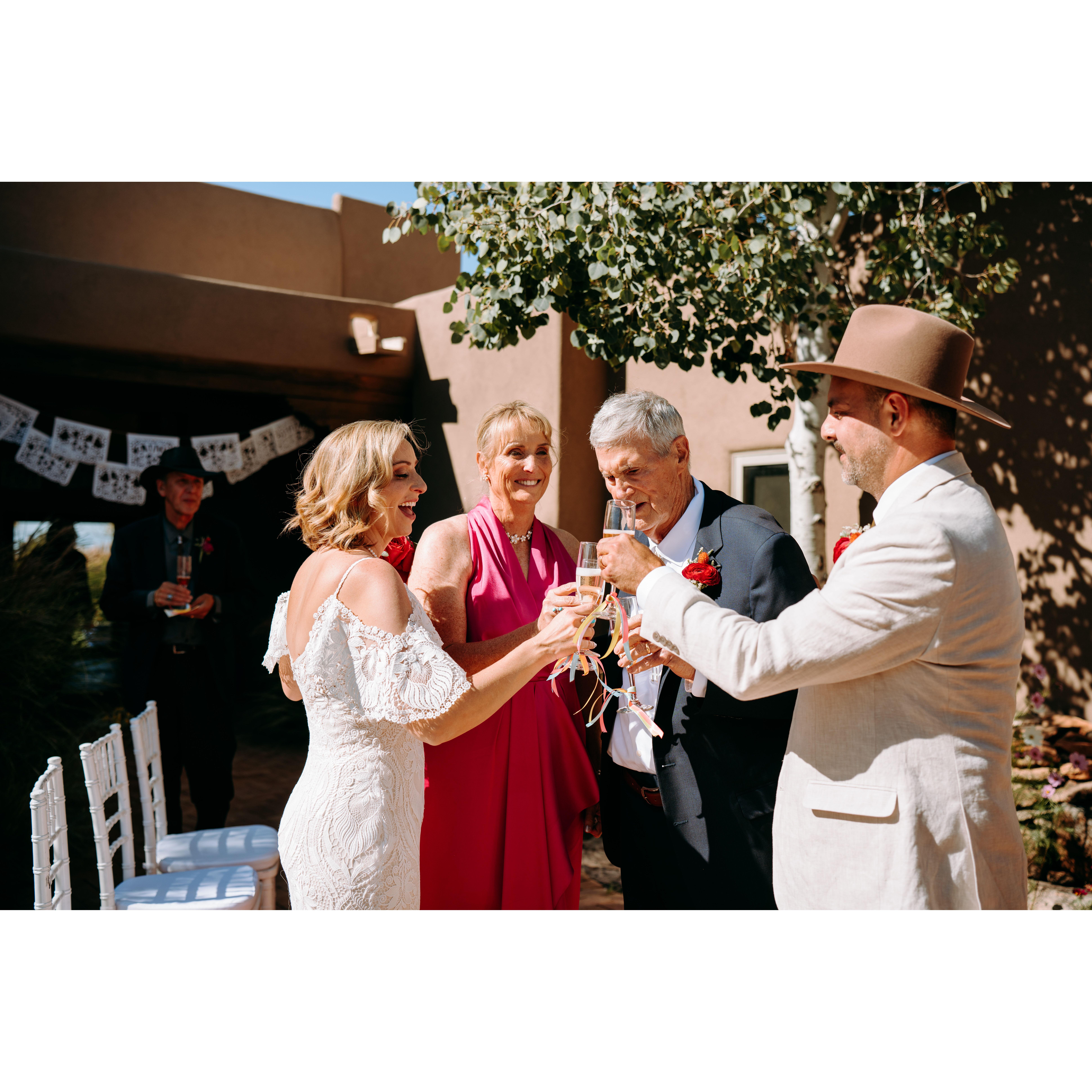 A toast - Jenn, Debi and John (Jenn's Mom and stepdad) and Shae clink champagne glasses