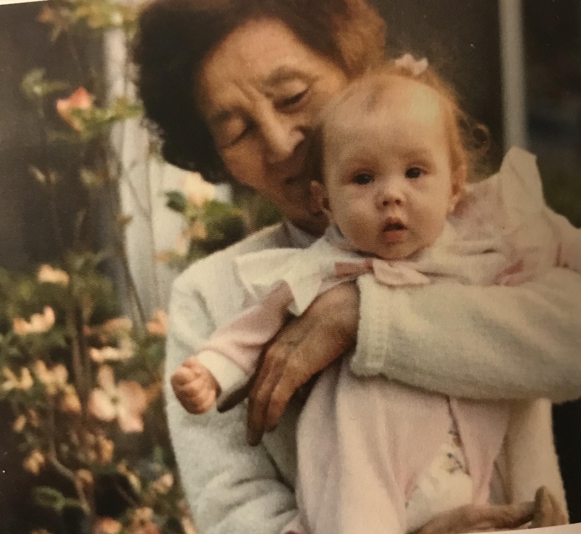 Alyssa being held by her Halmoni. Her Halmoni took care of Alyssa and her sister Natalie as children when their mom was working and their dad was in law school. They miss her every day.