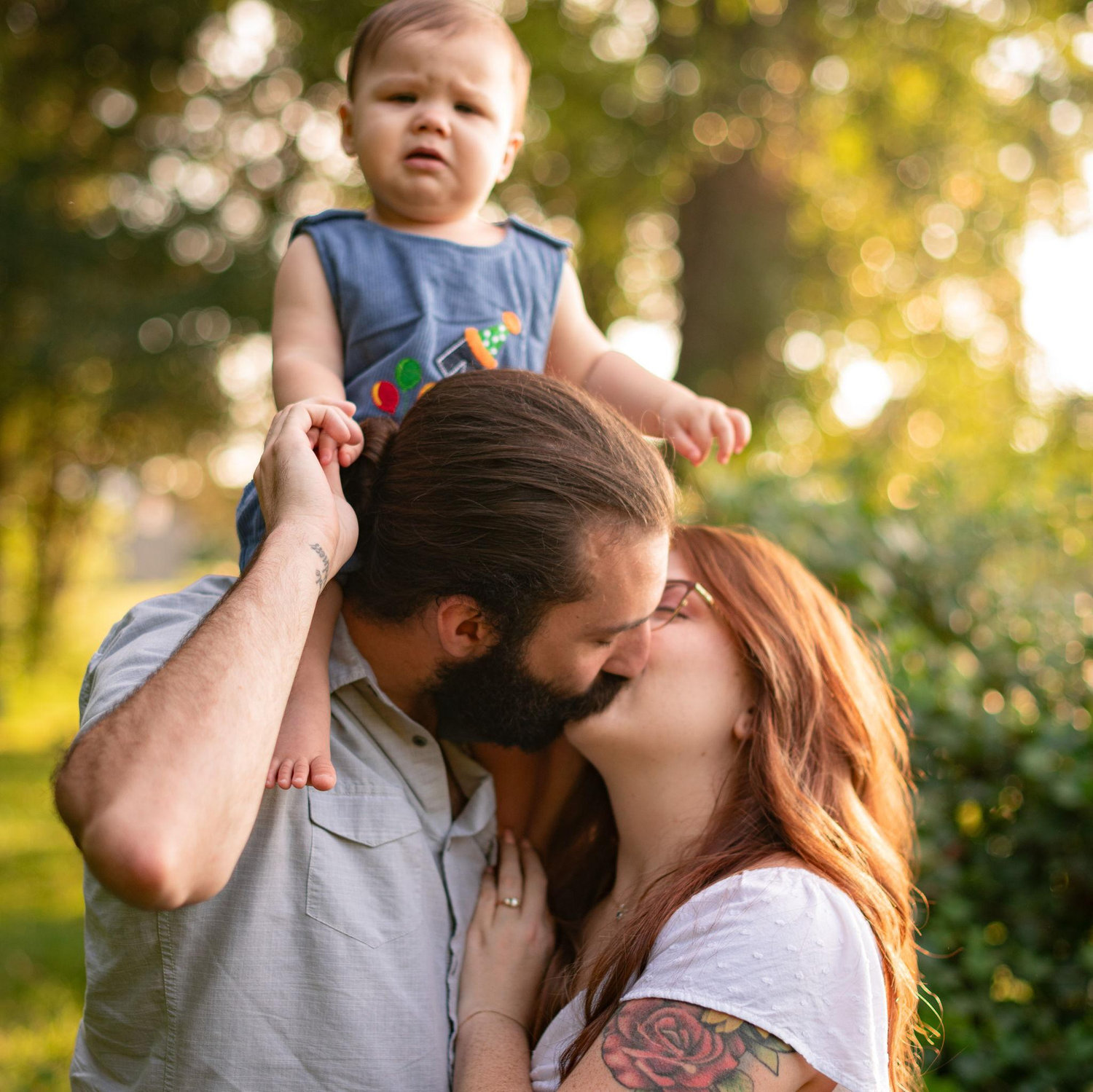 He doesn't seem to be very thrilled about his parents kissing..
