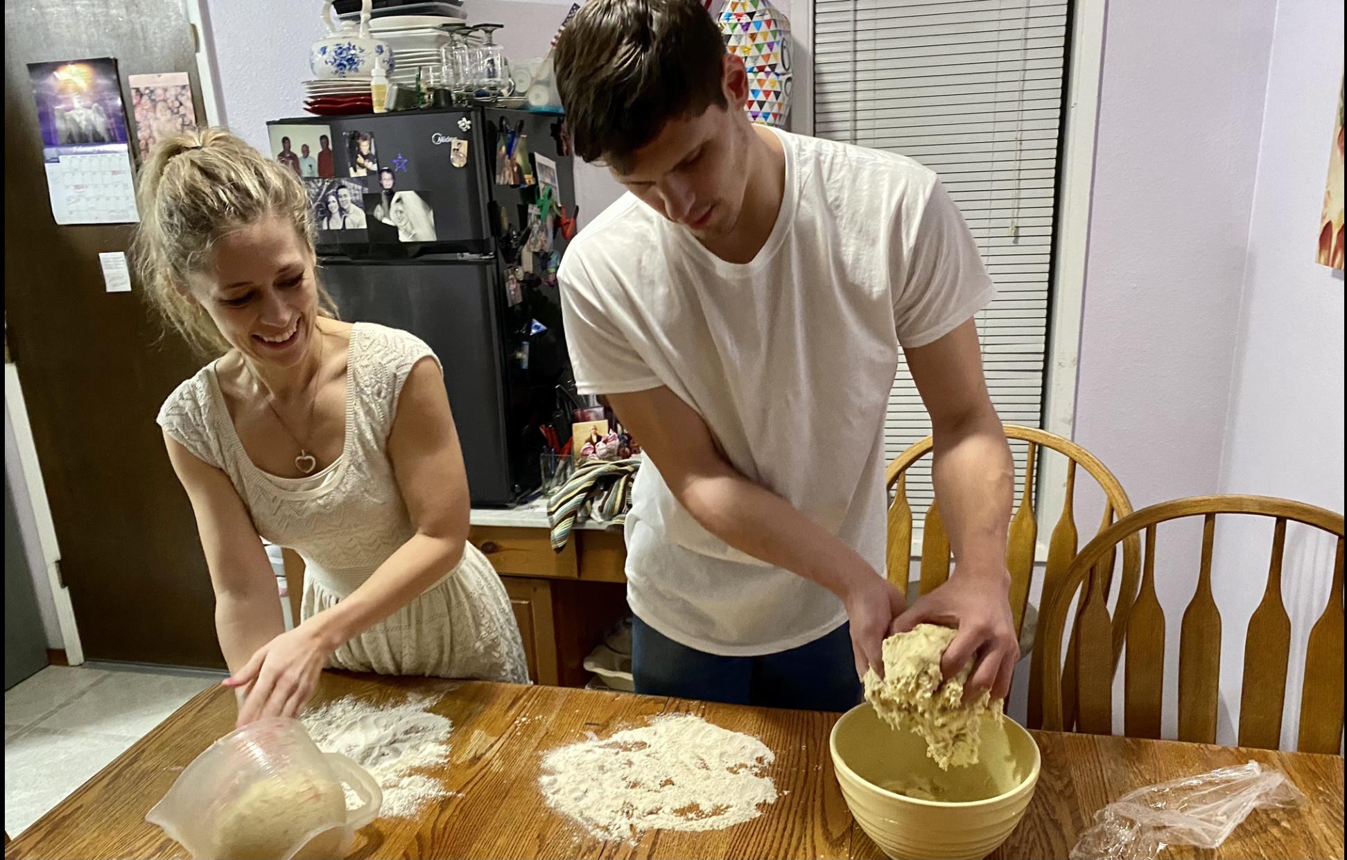 Brandon teaching Tanna how to make pizza from scratch.