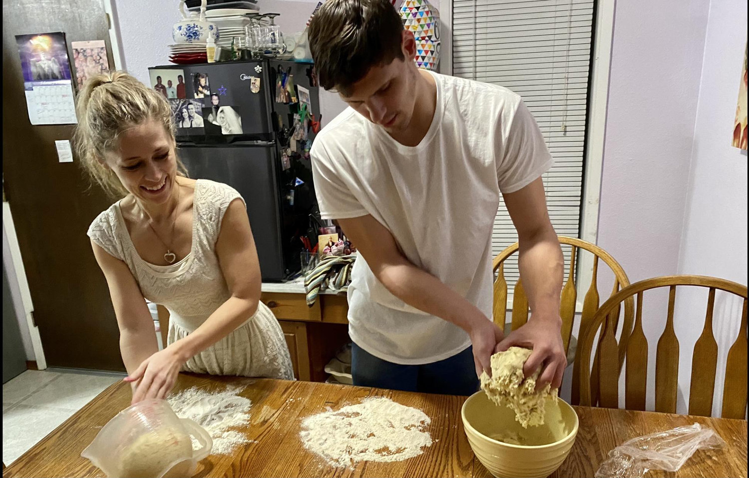 Brandon teaching Tanna how to make pizza from scratch.