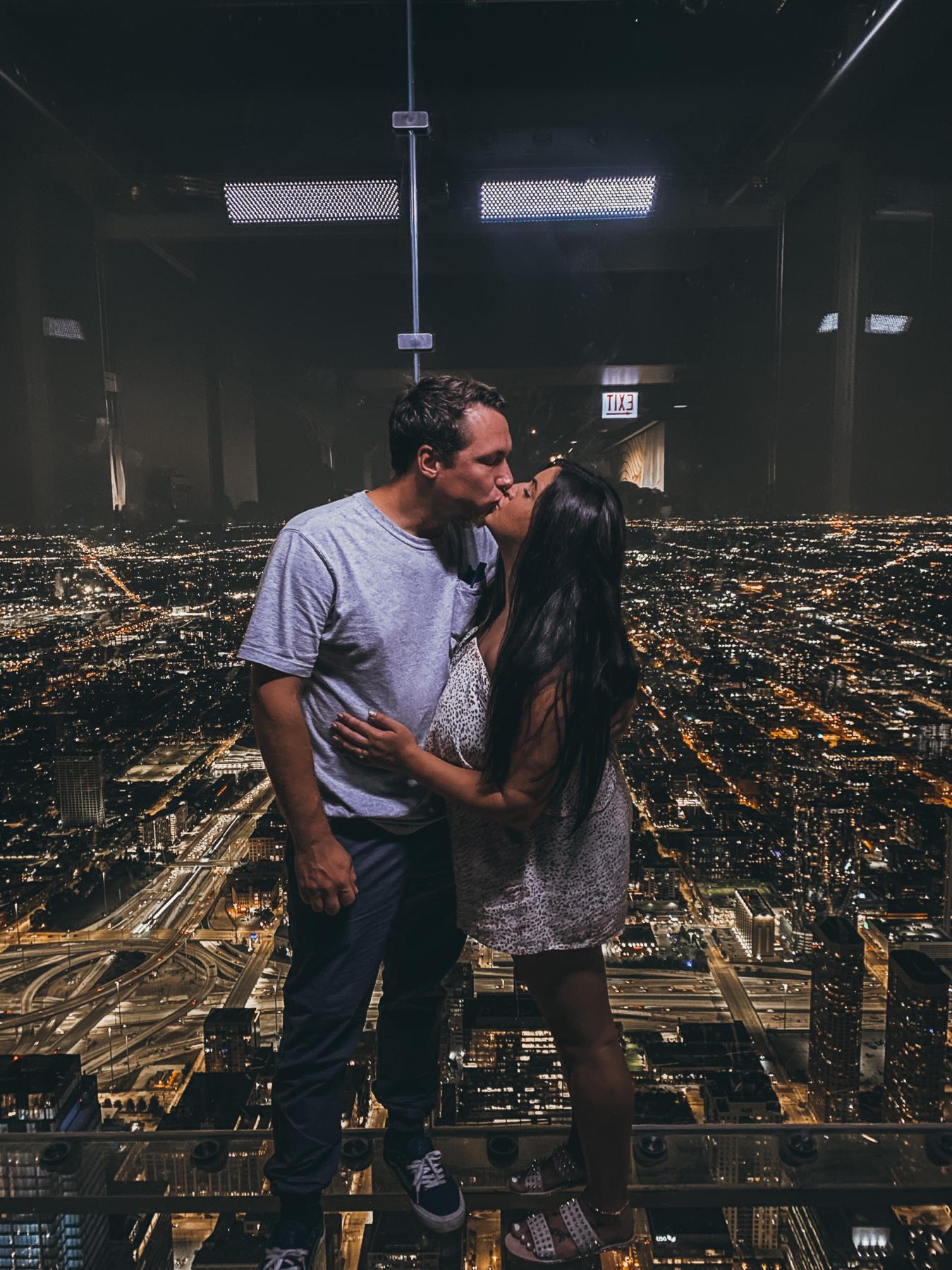 We took our love to new heights! This was taken at the Sky Deck in Chicago. We stood in line for an hour to have 60 seconds to quickly take some pictures and soak up the view!