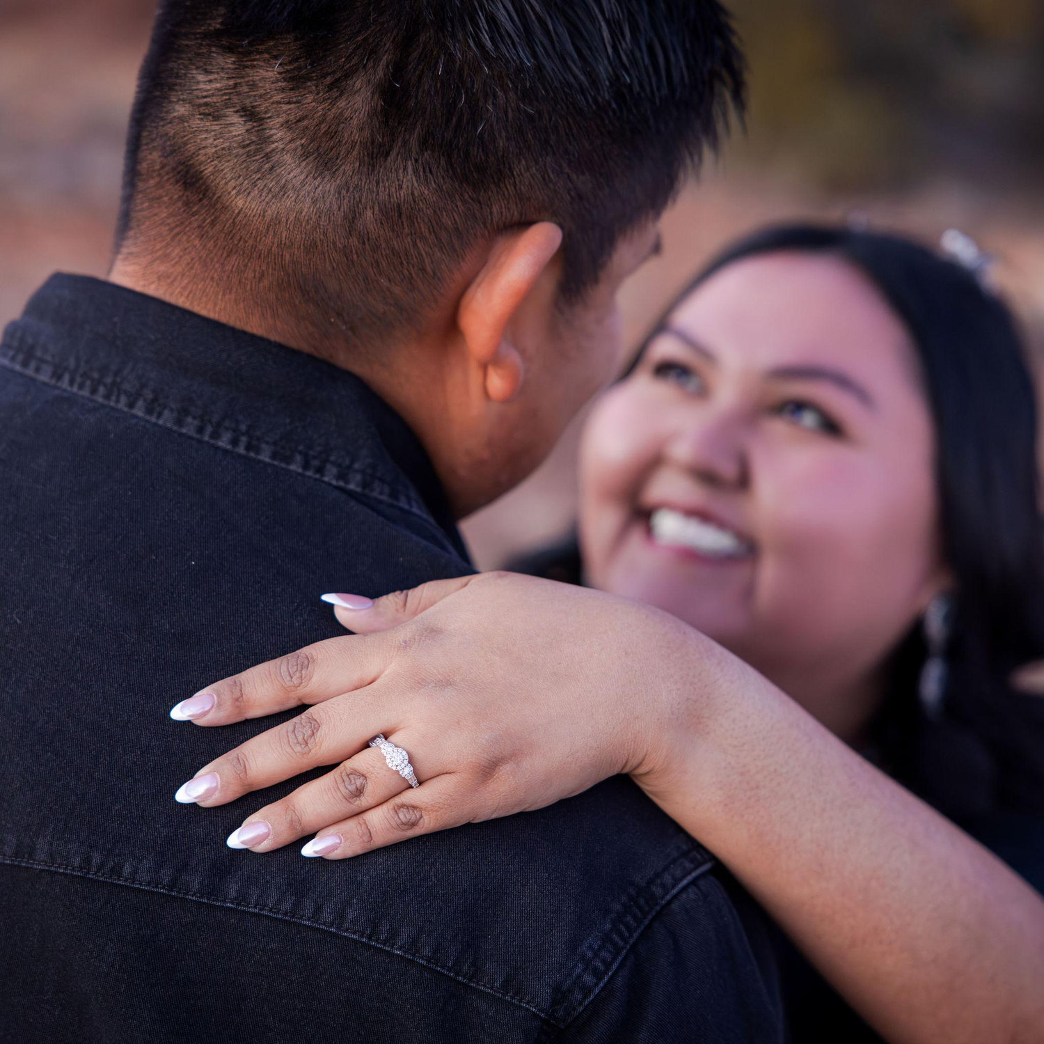 Showing off the engagement ring.
