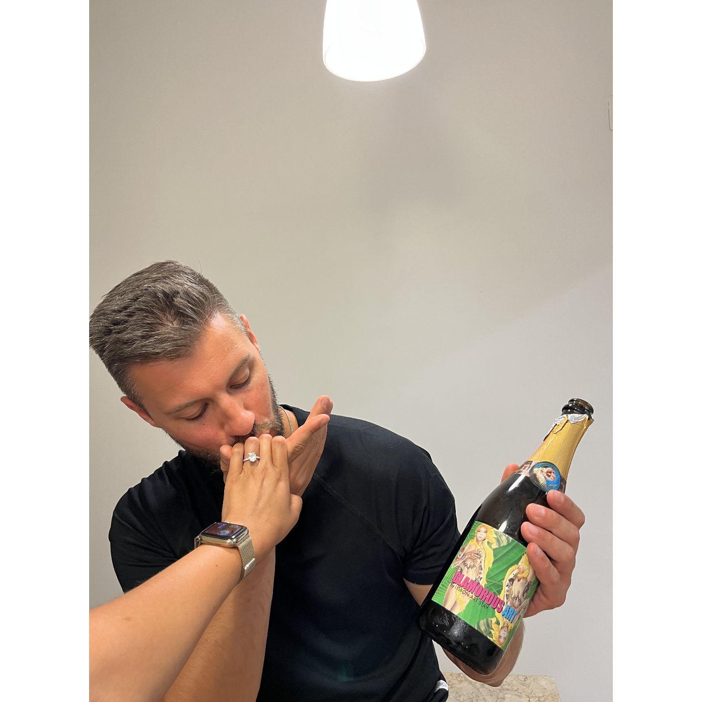 Moments after Mike's proposal. Also pictured, the fake Amazon ring Mike travelled with and the only bottle of wine Mike could convince the bar downstairs to sell to him just an hour prior. 😂