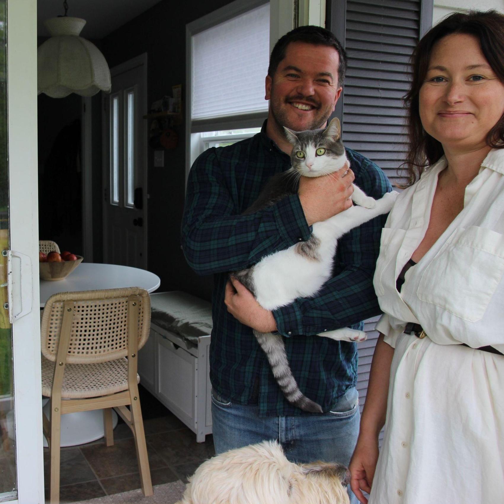 Ryan and Ashley at home in Enfield with their goldendoodle Hughie and cat Kubota