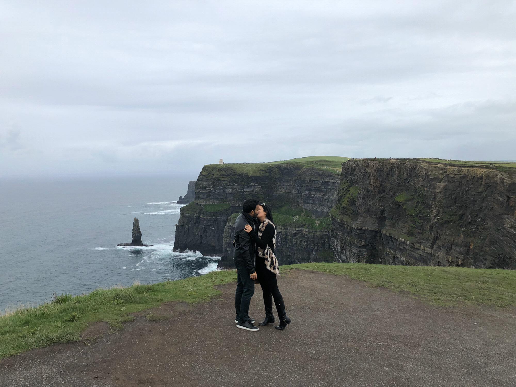 Grabbing a kiss on top of Cliffs of Moher, Ireland.