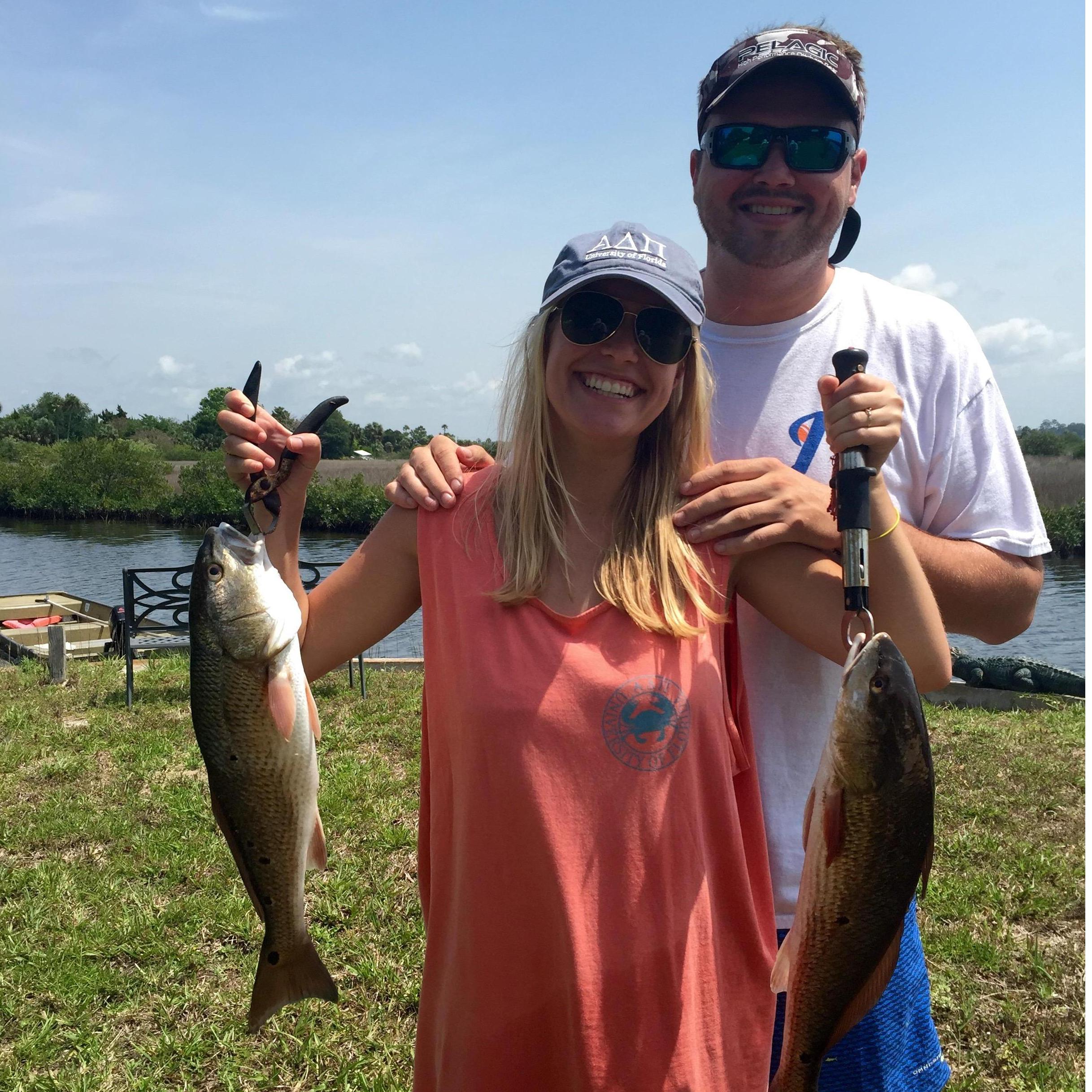 Cory proudly posing with Claudia and the two red fish she caught - 2015