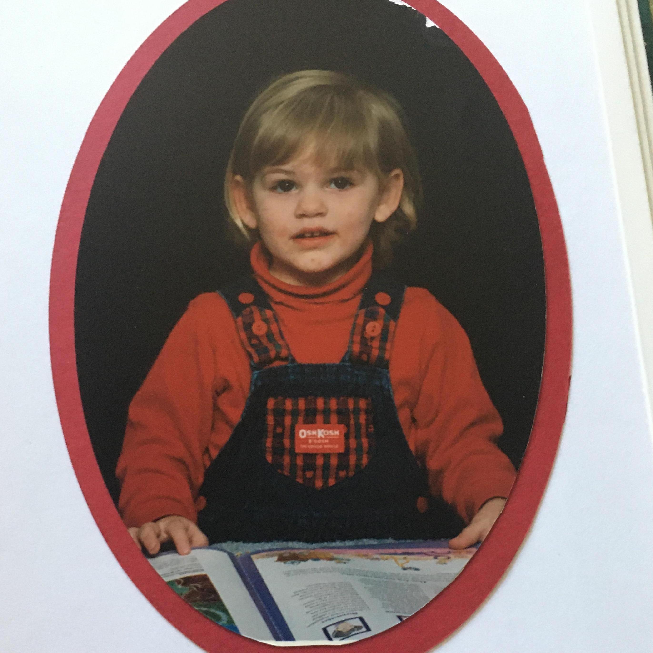 Elizabeth: 2 years old. She loved to read books as a child. Good for her! (1996)
