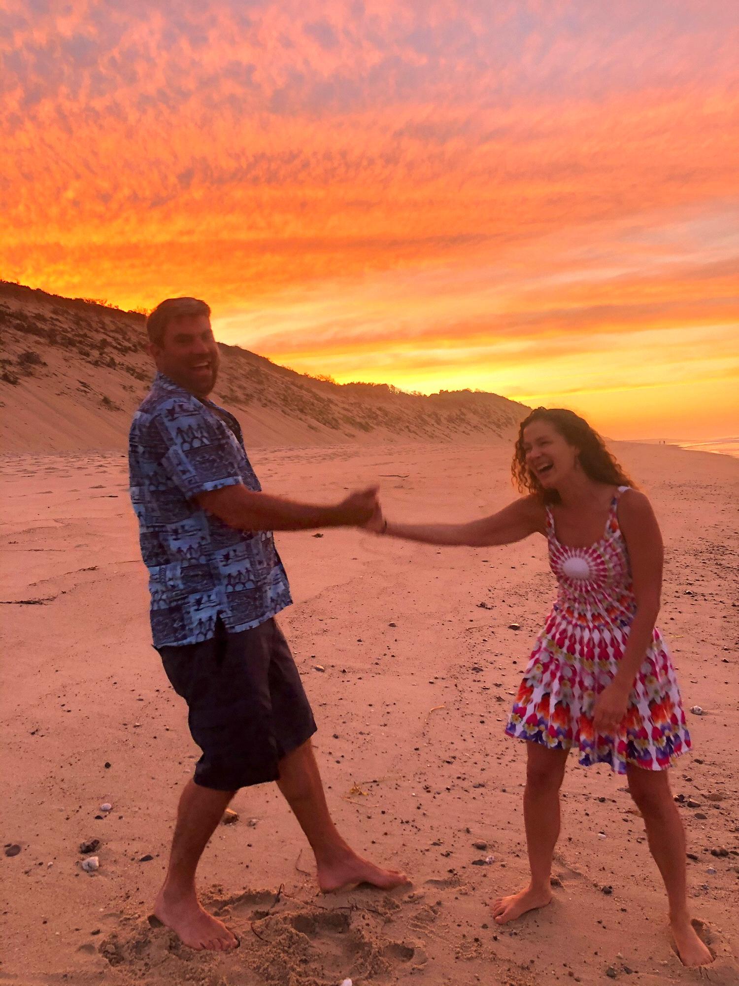 High-fives on the beach after getting engaged in Wellfleet, Cape Cod