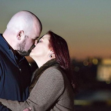 Smooching in front of the Lincoln Memorial at night.