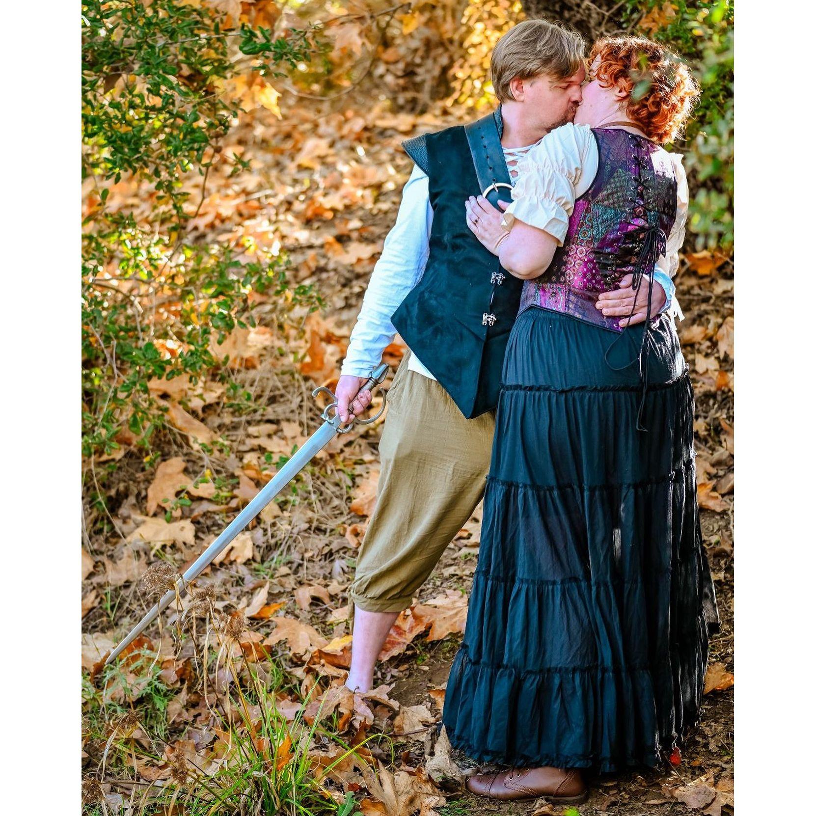 We wore our RenFaire garb for our engagement photos because this is our next big adventure, obviously! (And any photoshoot with Alan requires at least one sword.)