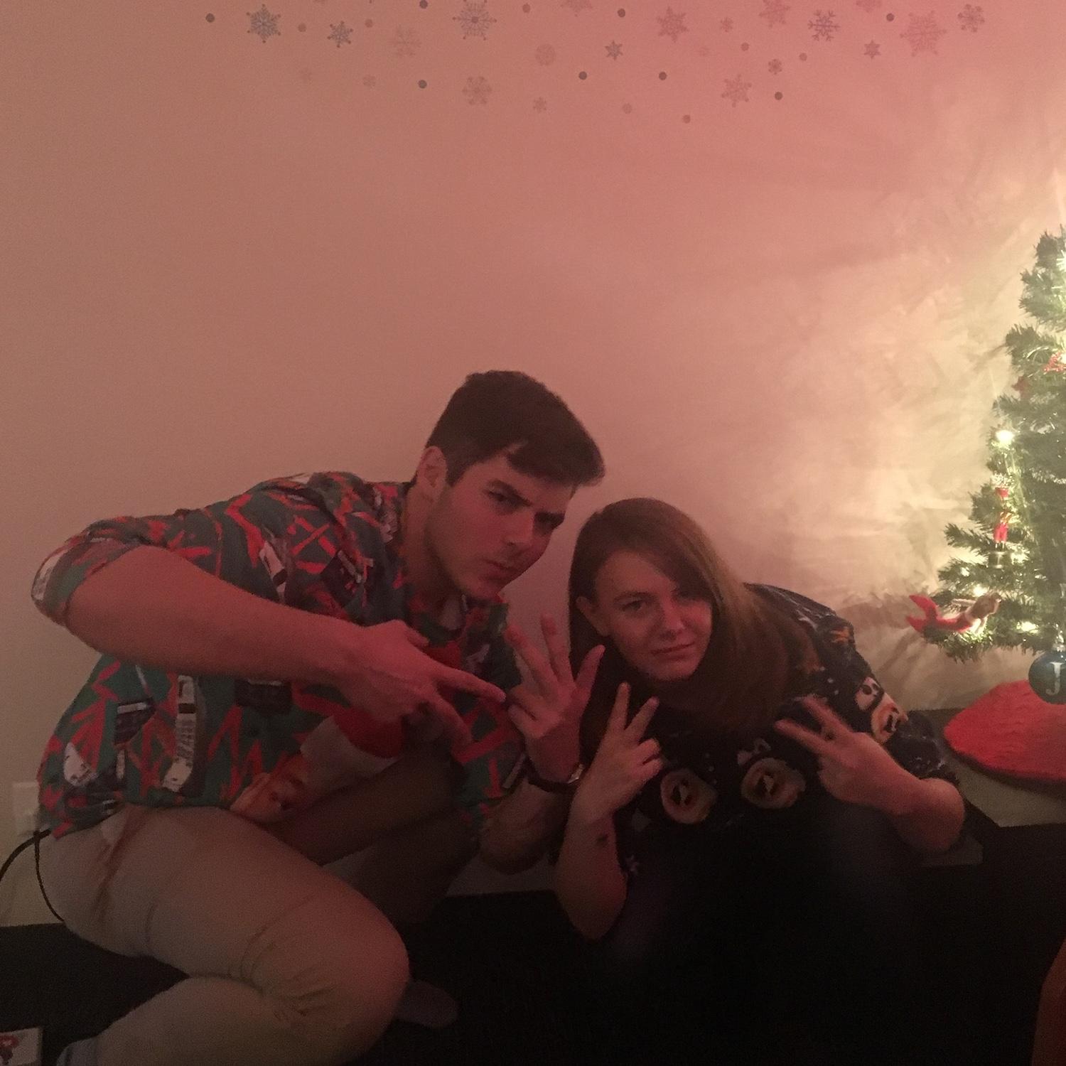 Jackson and Lindsay slavic squatting at Lindsay's Christmas party in 2017