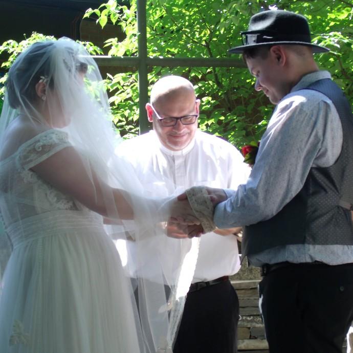 In lieu of the traditional exchanging of rings, we chose instead to take part in the celtic tradition of hand fasting. We will be exchanging rings at our Vow renewal before the reception.