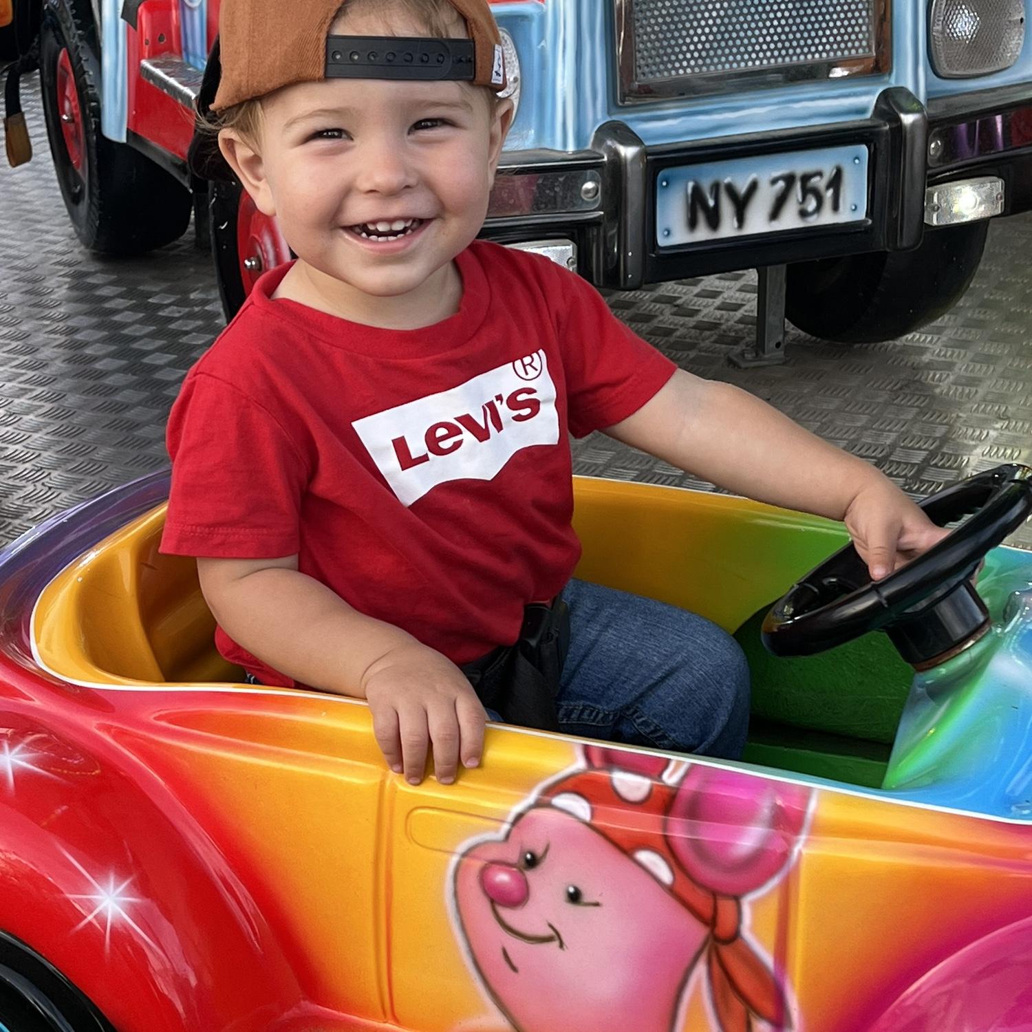 Roman almost 2 at the state fair on his first ride.