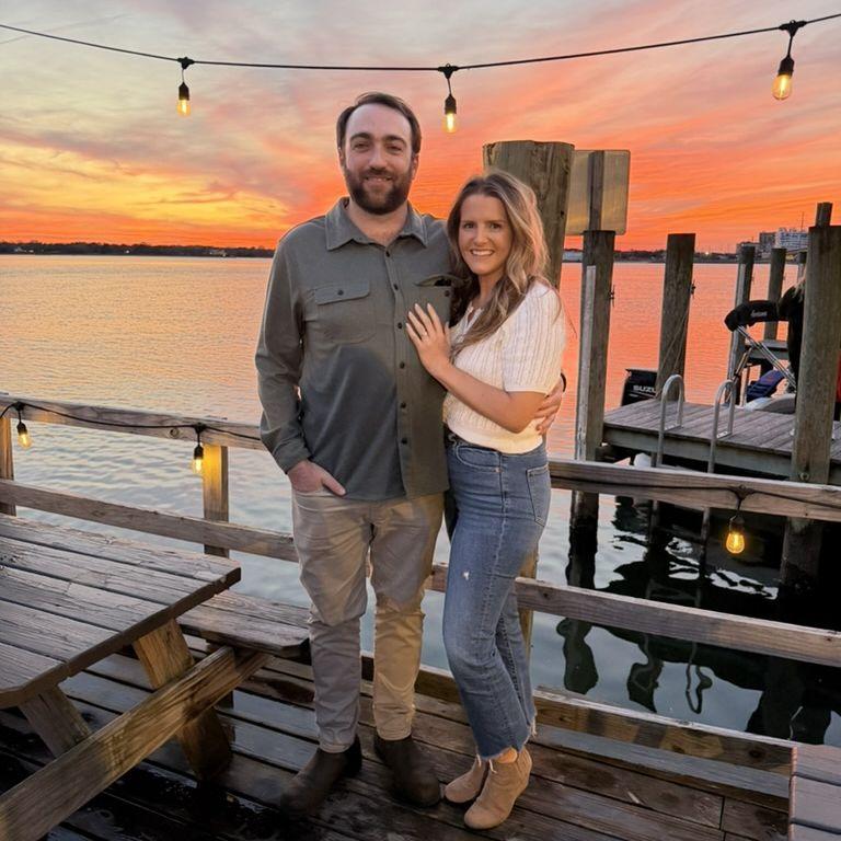 Celebrating our engagement and standing next to our "first date table" at Chick's Oyster Bar