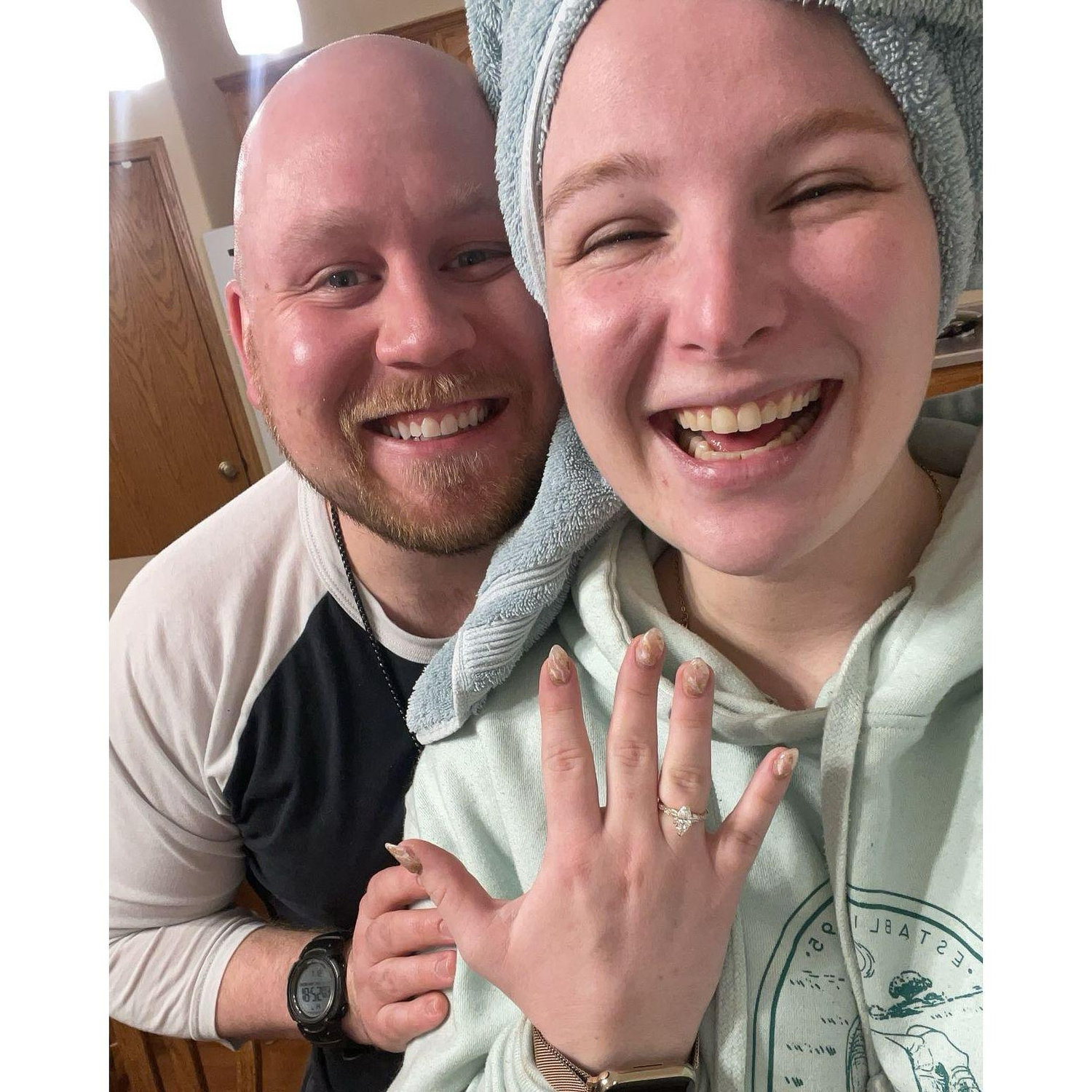 The "just proposed" photo, filled with joy, wearing sweatpants and a hoodie, hair still damp from the shower. LEGO was involved and it was the perfect low-key proposal.