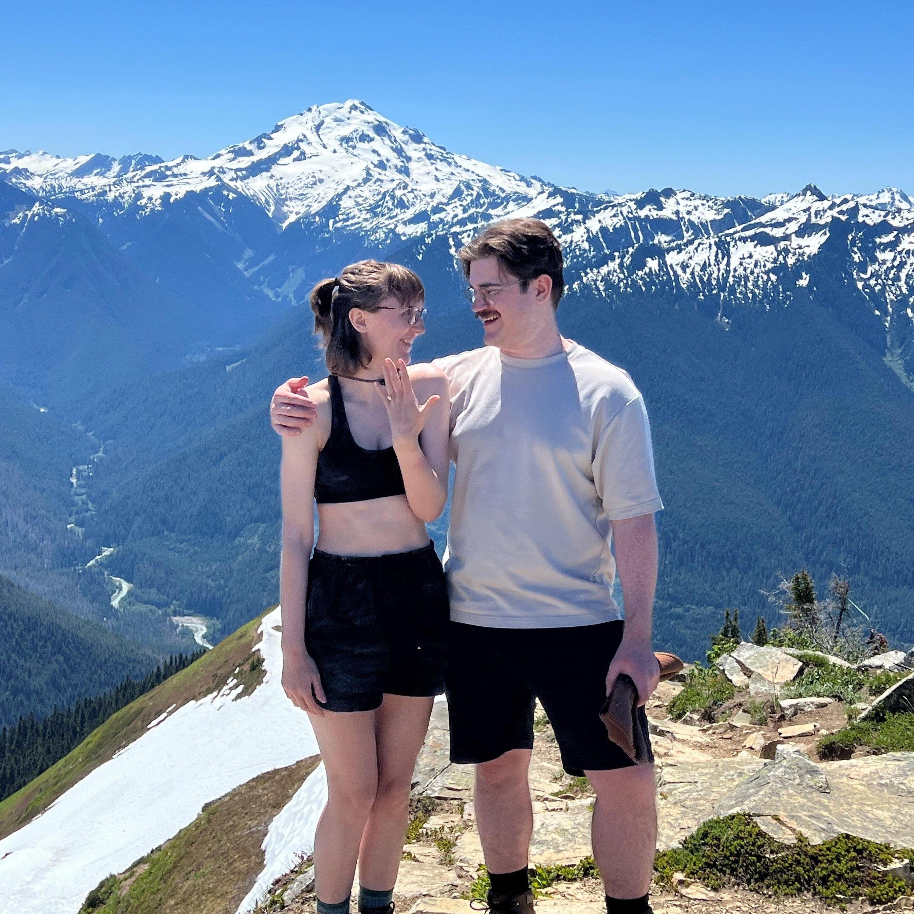 We stopped some hikers before heading back down the mountain to take our photo after getting engaged.
