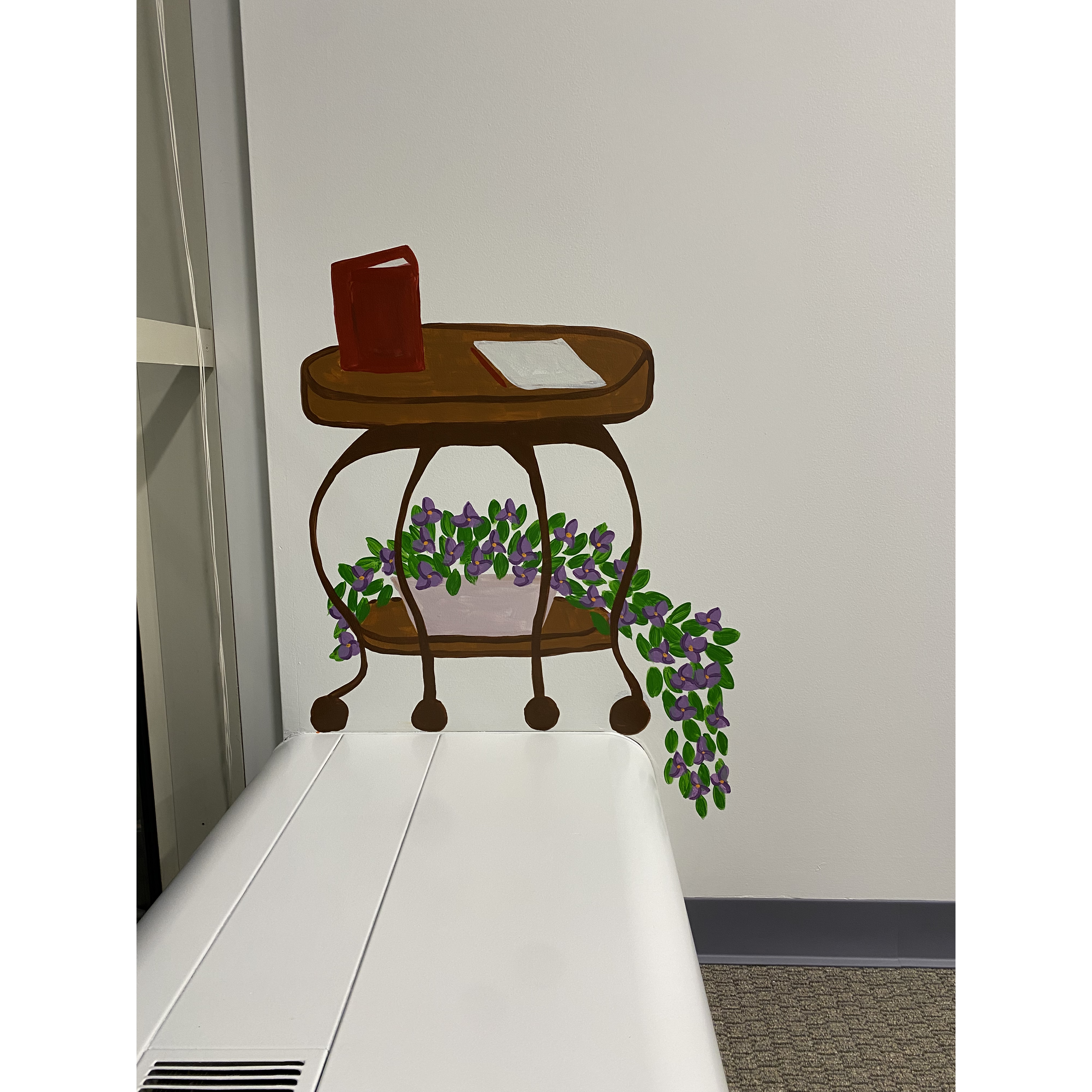 Accent: side table with a address book, letter, and bougainvillea