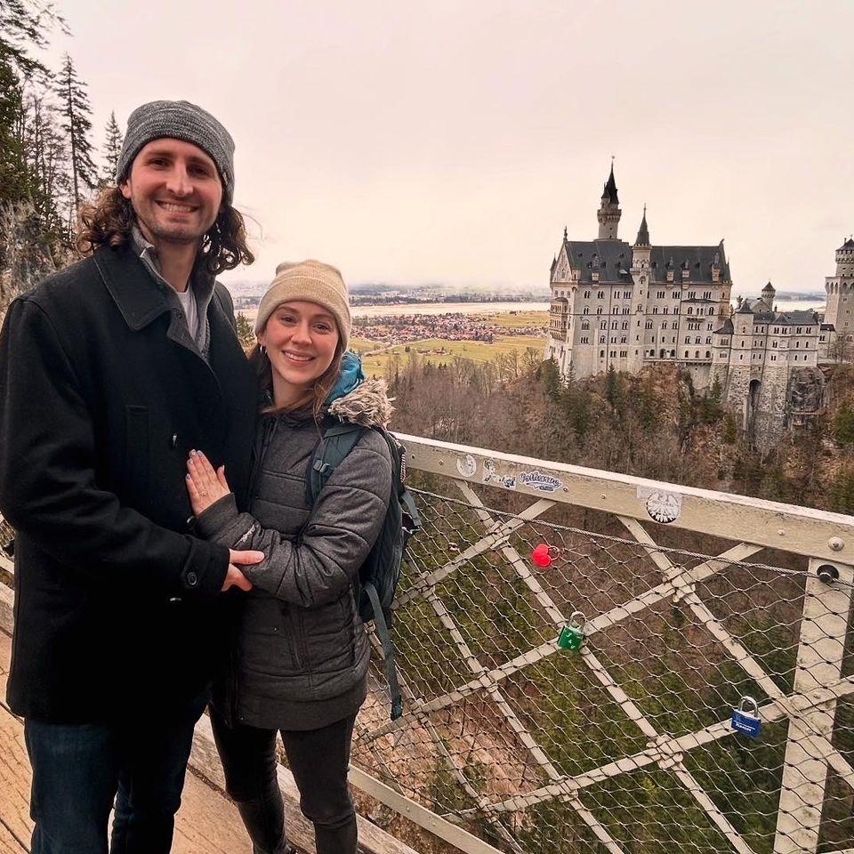 Kleigh proposed on Marienbrücke overlooking Neuschwanstein Castle. He first asked in German, to which Maggie replied "huh?".