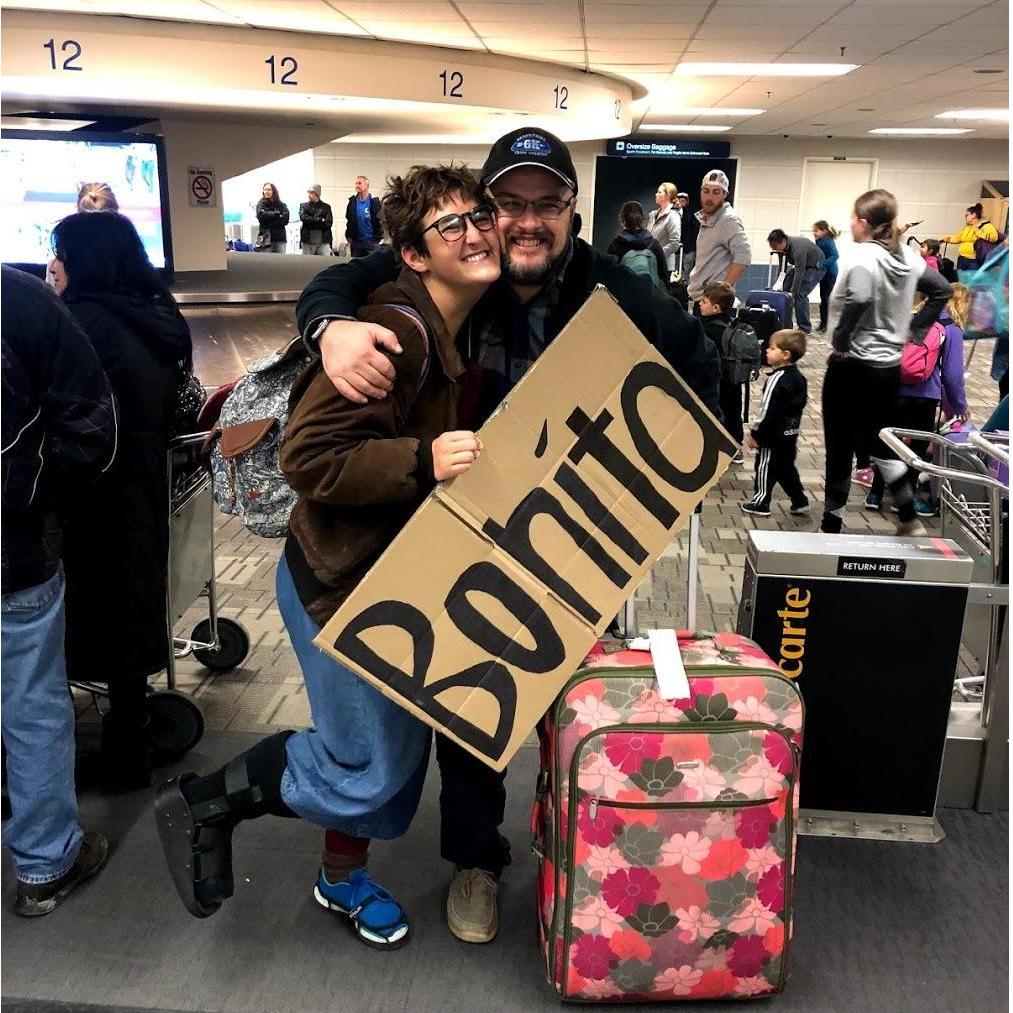 Minneapolis, MN, December, 2018 | Austin greeted Molly at the airport with a giant sign when she went for Christmas to meet his family!