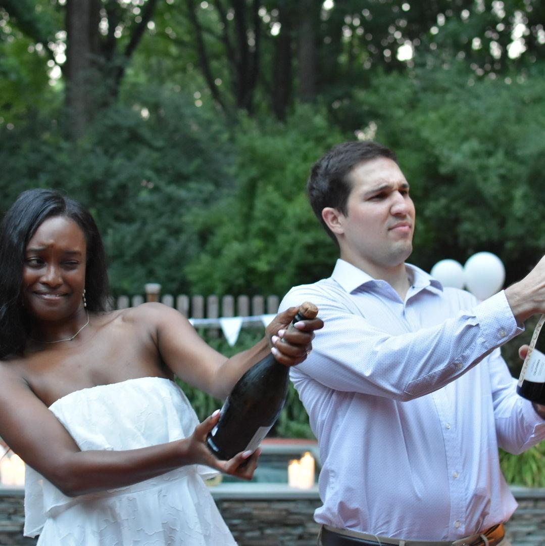 Our engagement party, July 2023. We were struggling to pop the bottles!