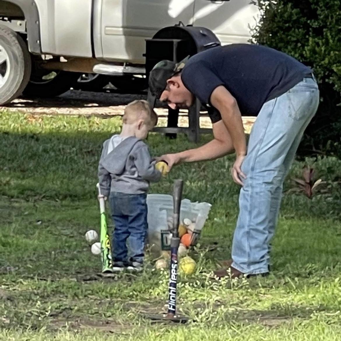 Bryan helping Luka play T-ball against Eadyn & Ebo