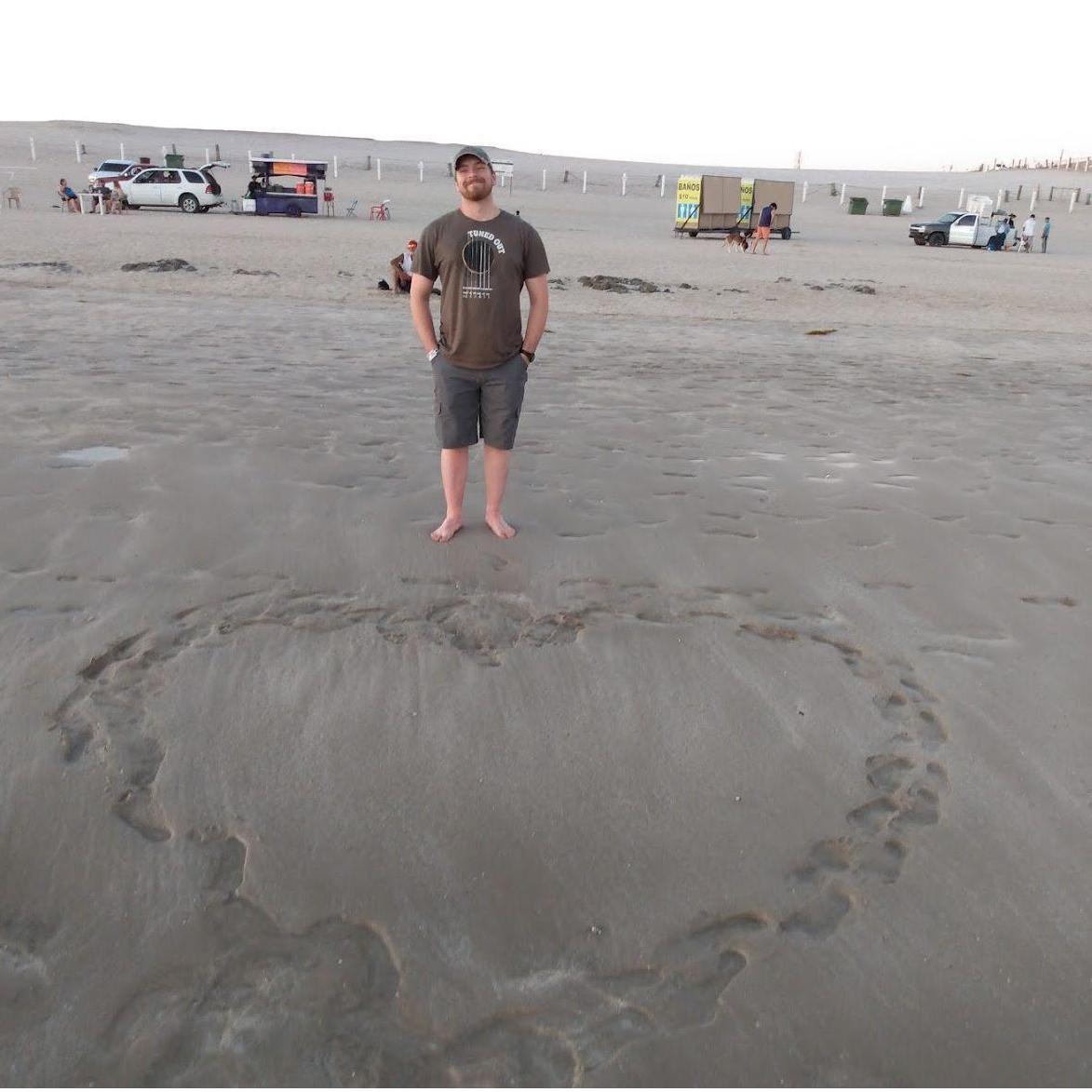 Walk on the beach and making a heart in the sand