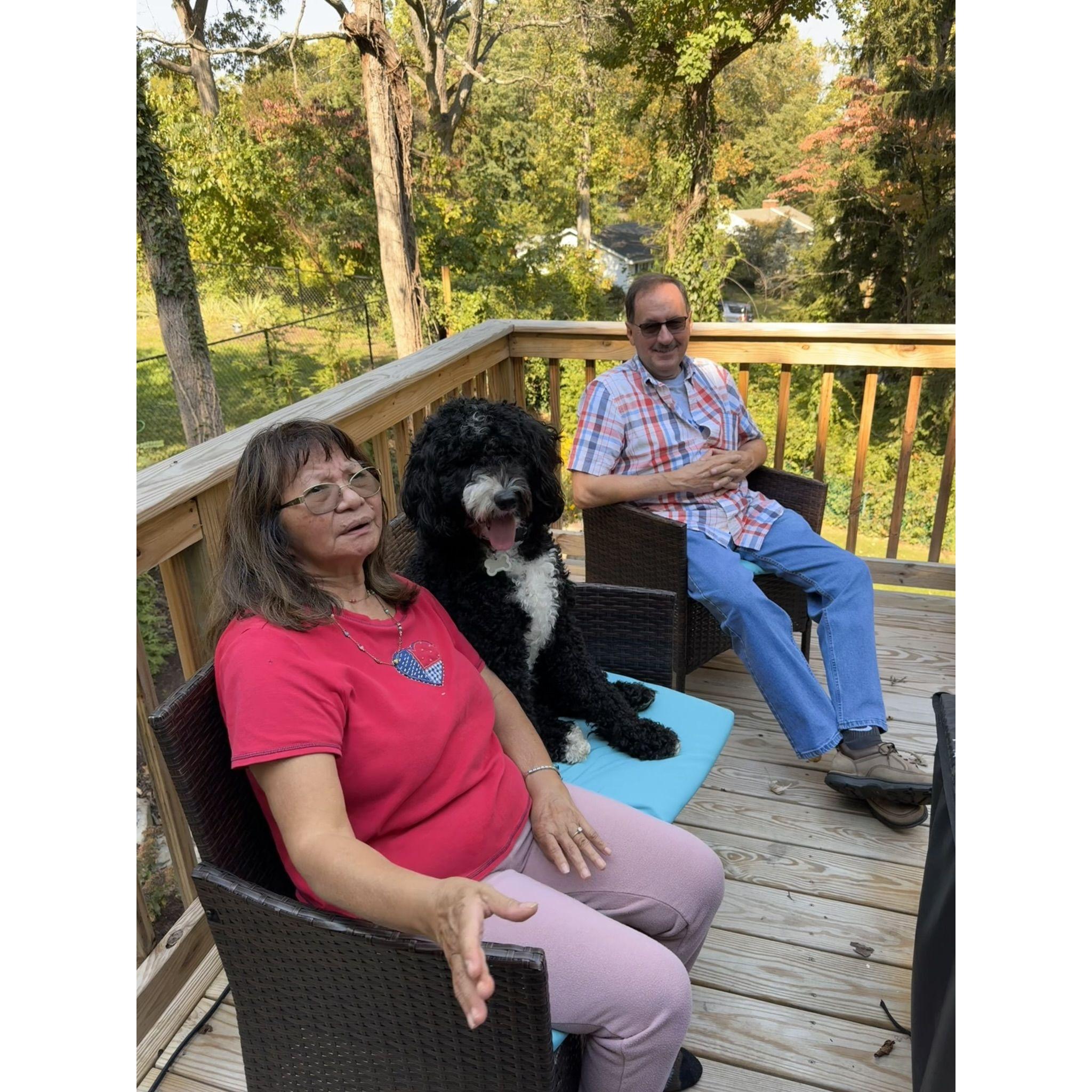 Moki enjoying porch time with his grandparents - he's notorious for stealing Micky's mom's seat.
