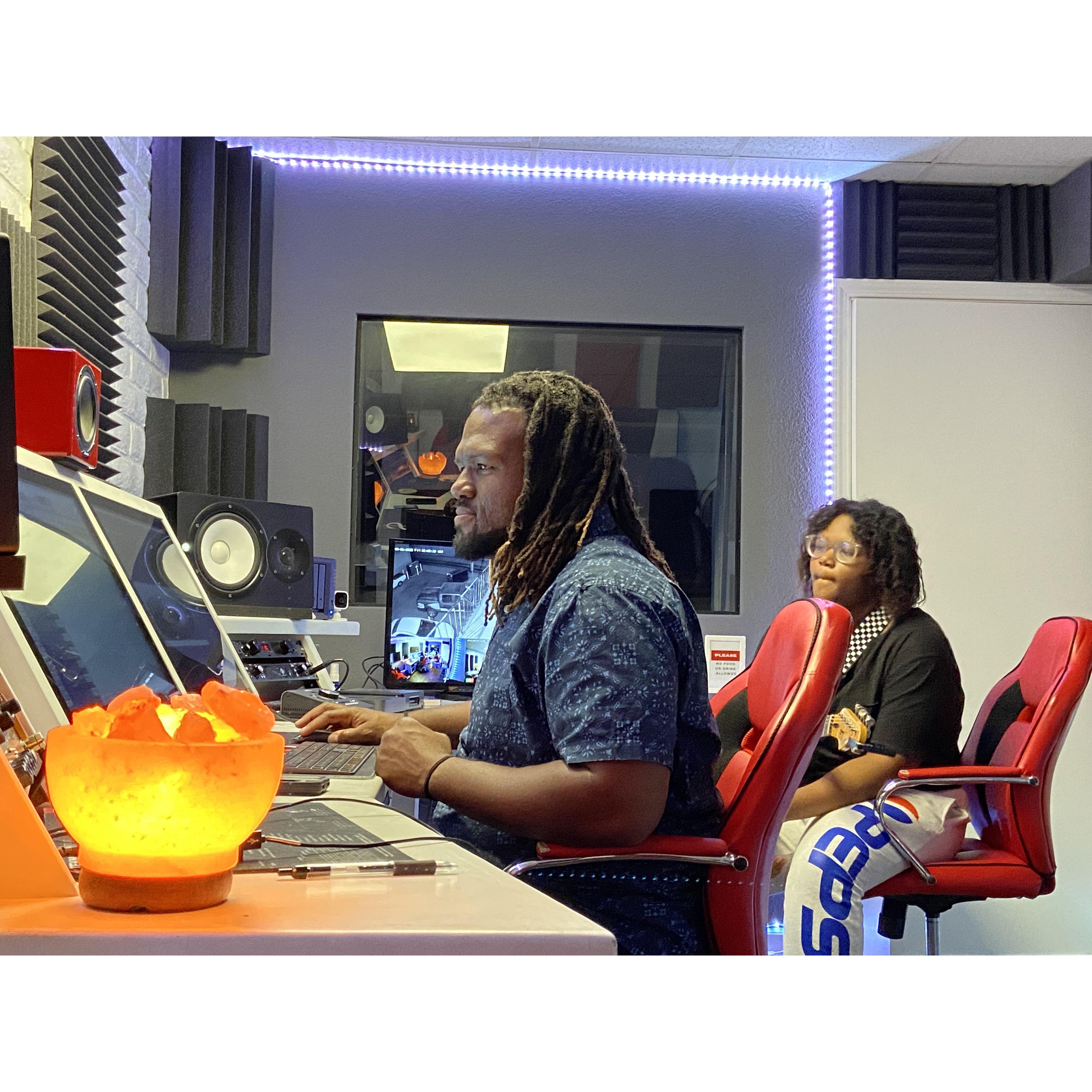 Albert and Laila working in the studio laying down her music. Laila composes, plays the guitar, and sings!