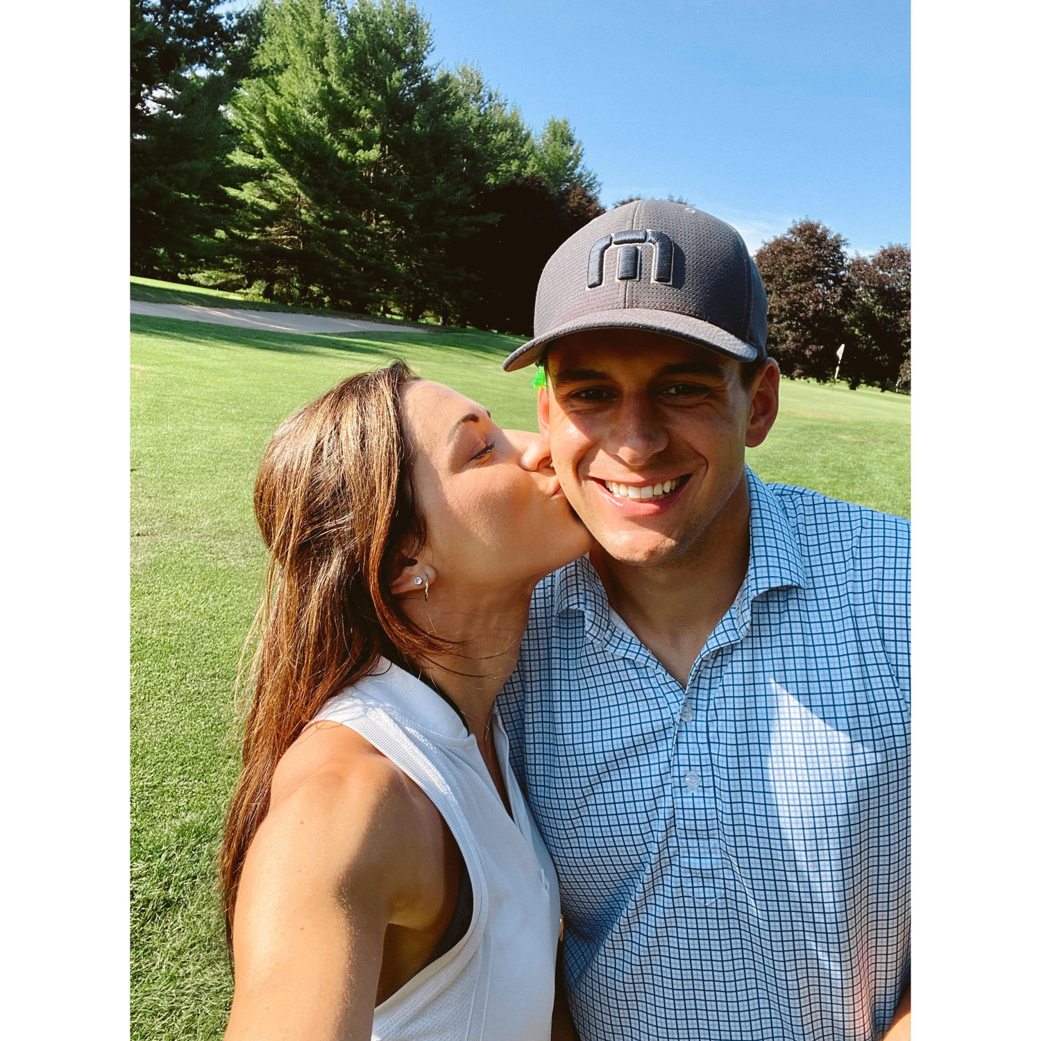 Anthony teaching Leah to golf