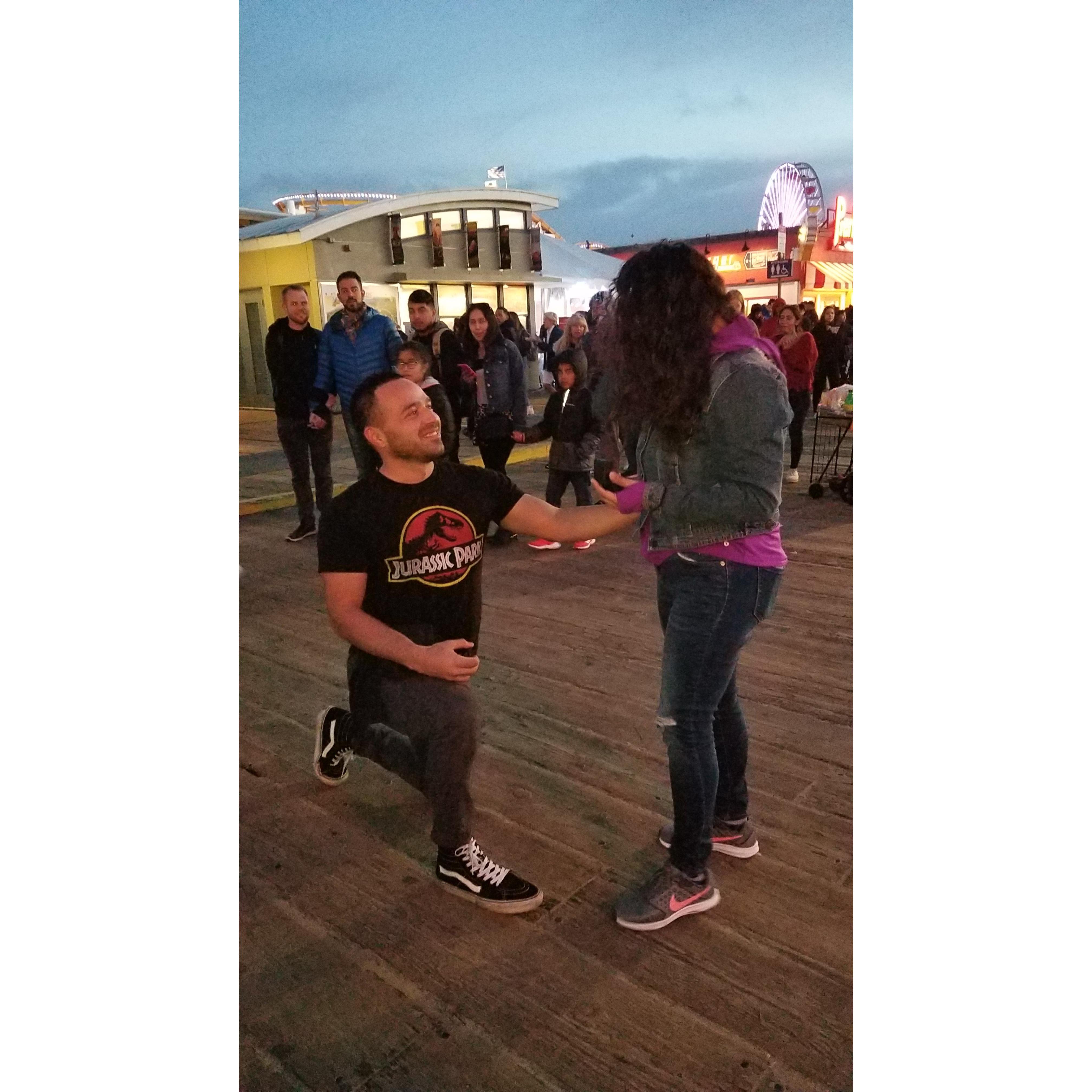 Surprise! He proposed to her on their one year anniversary front of their both families.