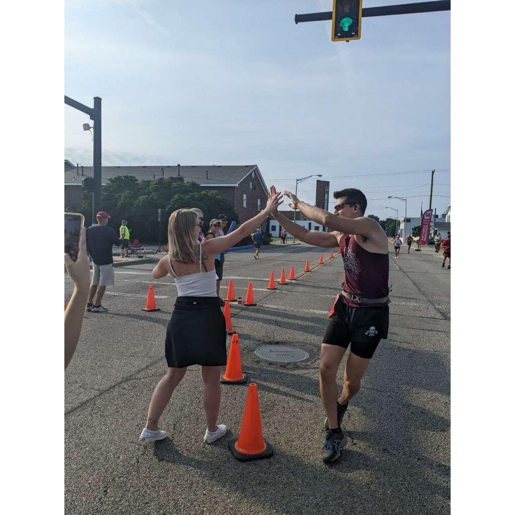 Brittany cheering Christian on running the 2022 AF marathon in Dayton Ohio.