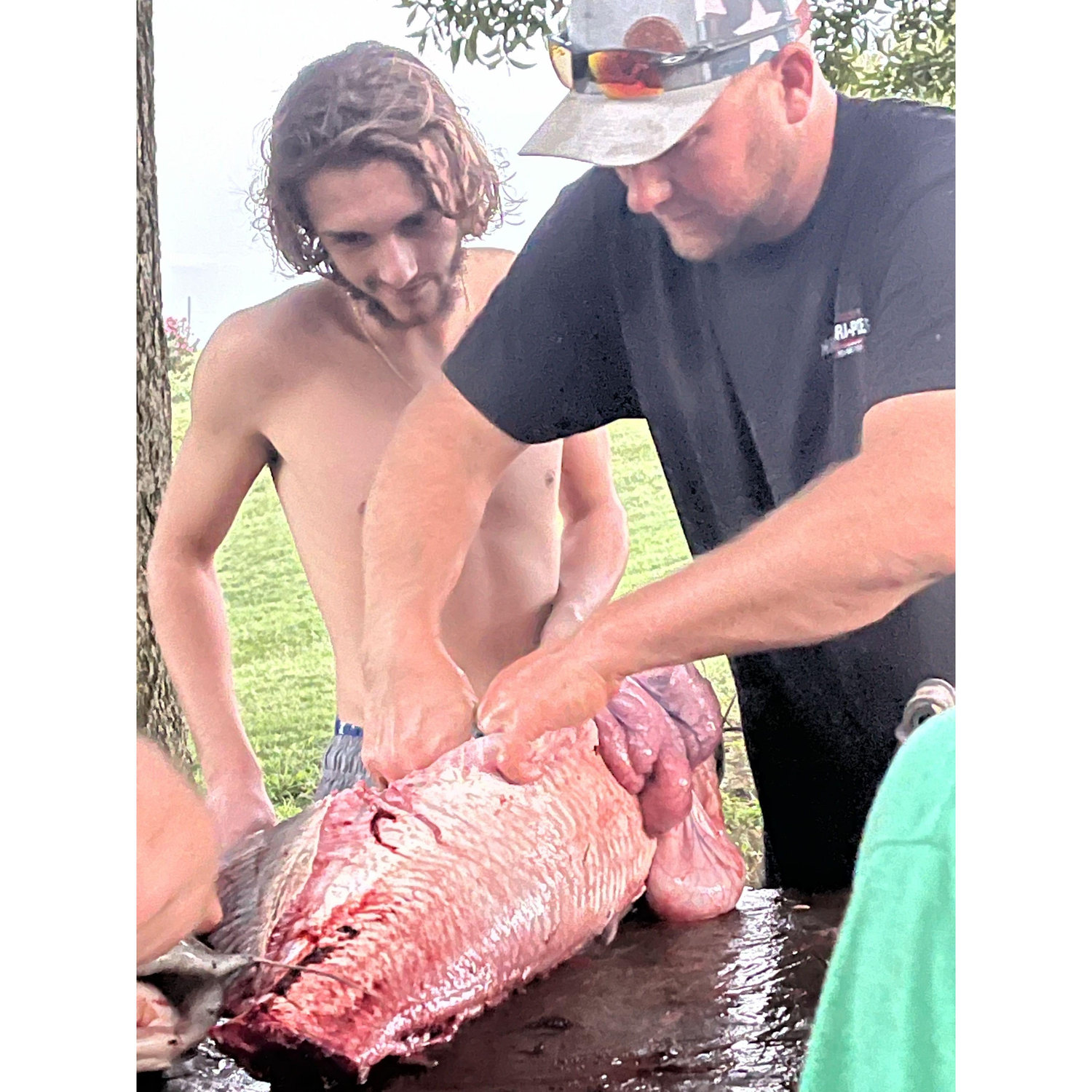 Jeff teaching Matt how to clean a catfish
