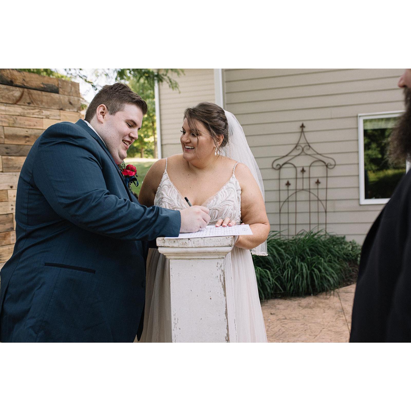 Signing the marriage license.