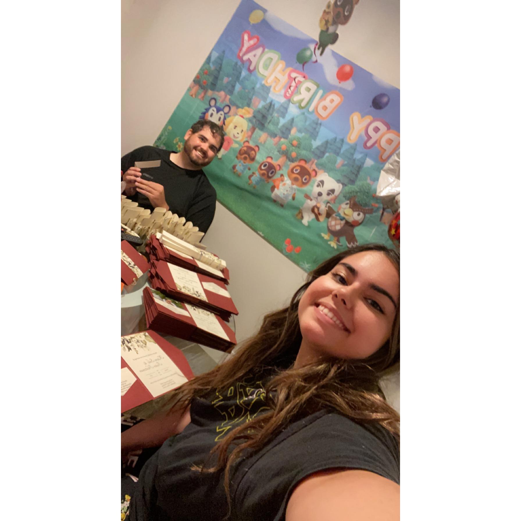 We spent 4 hours assembling our wedding invitations the night before we sent them out! (The banner is from the surprise animal crossing birthday party Foster threw for me lol)