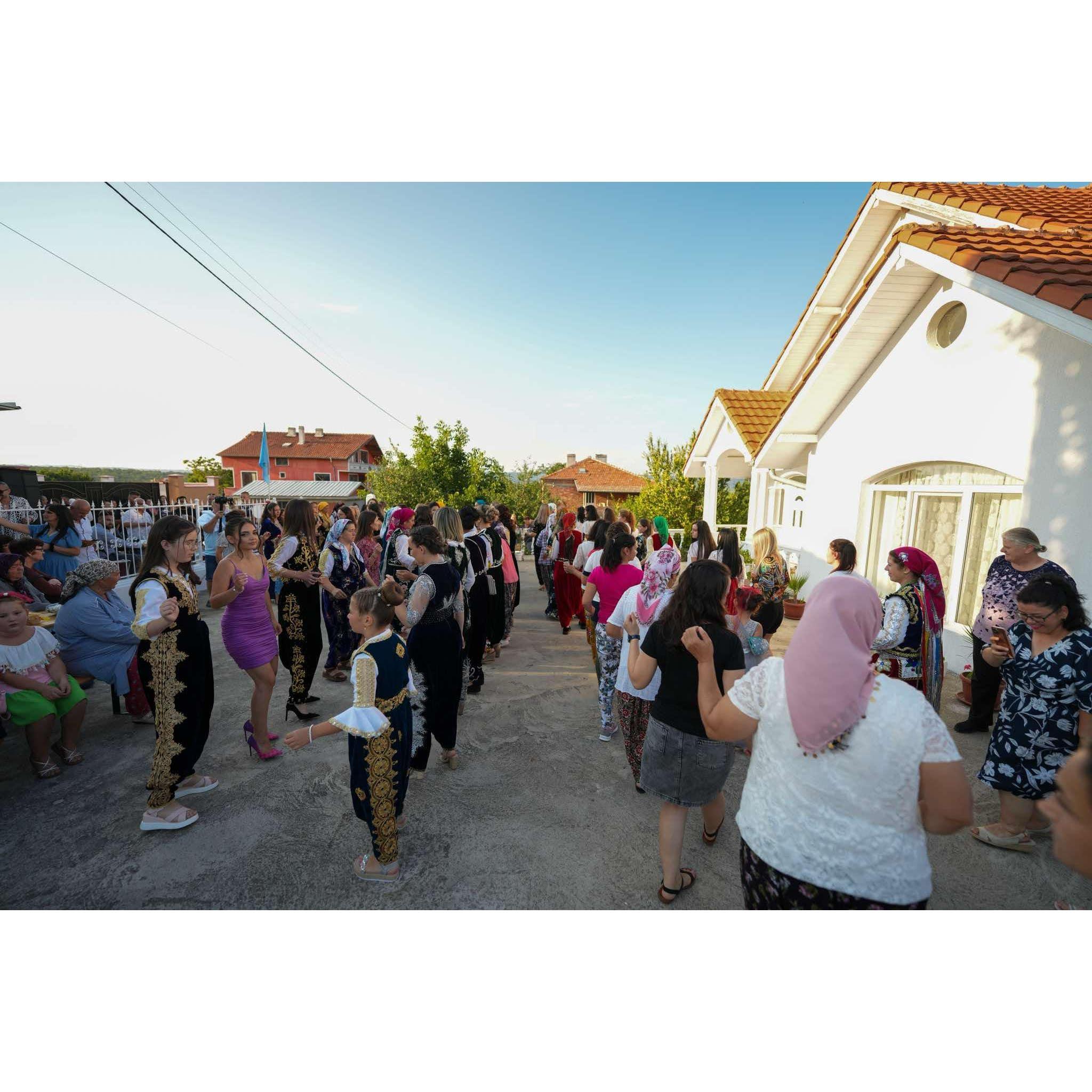 Before going to the village square, there is a traditional ceremony in front of the house with some dances and food.